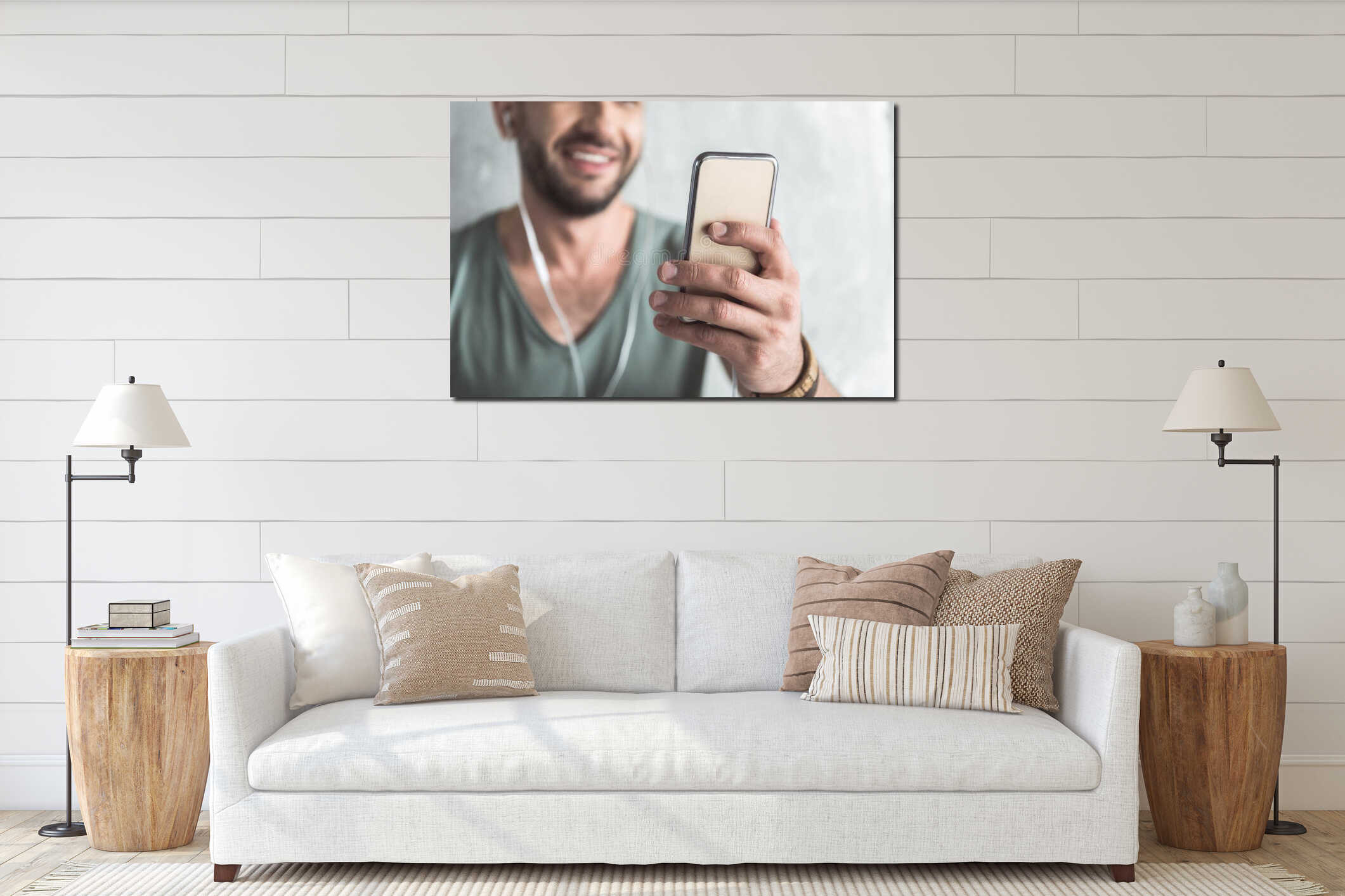 Cheerful cute guy is using his mobile phone interior mockup
