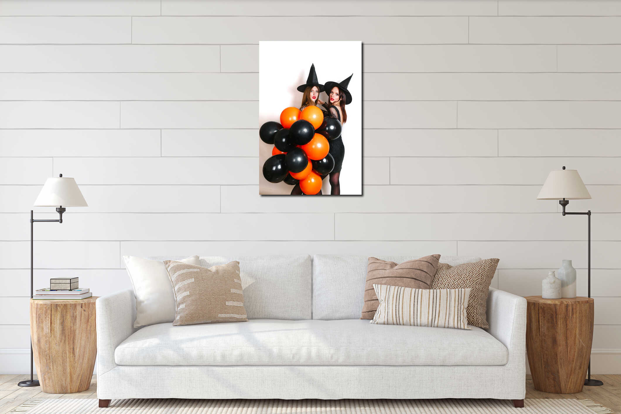 Two happy women in black witch halloween costumes with orange and black balloon on party over white background interior mockup