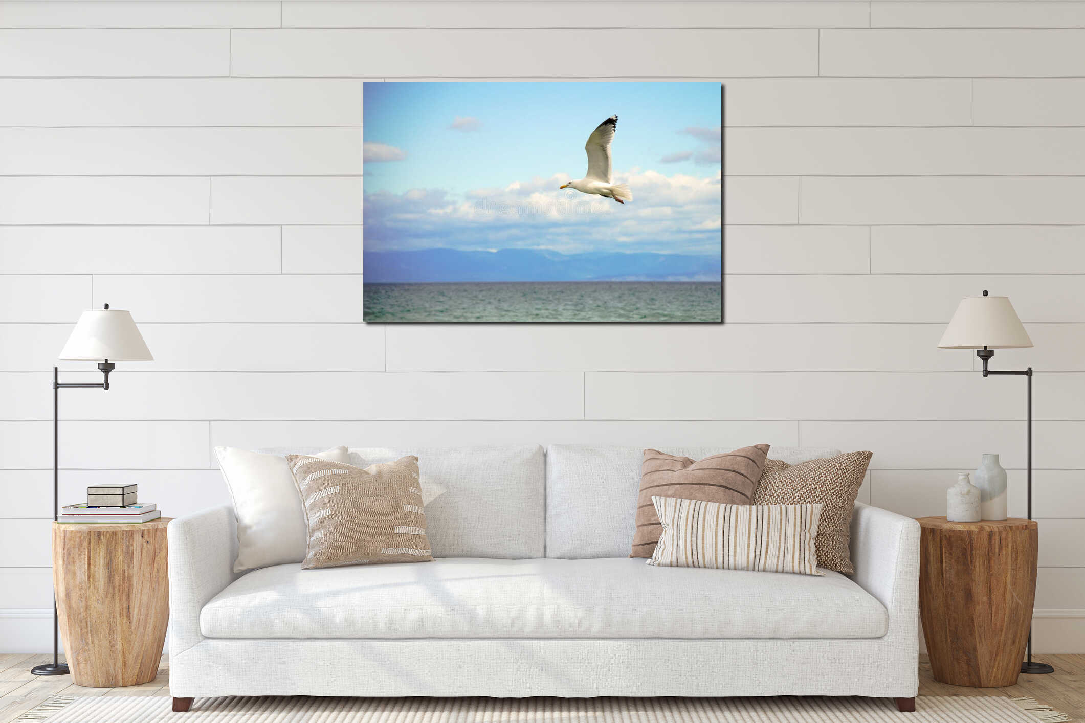 White seagull flying above the water surface with the sea and clouds background interior mockup