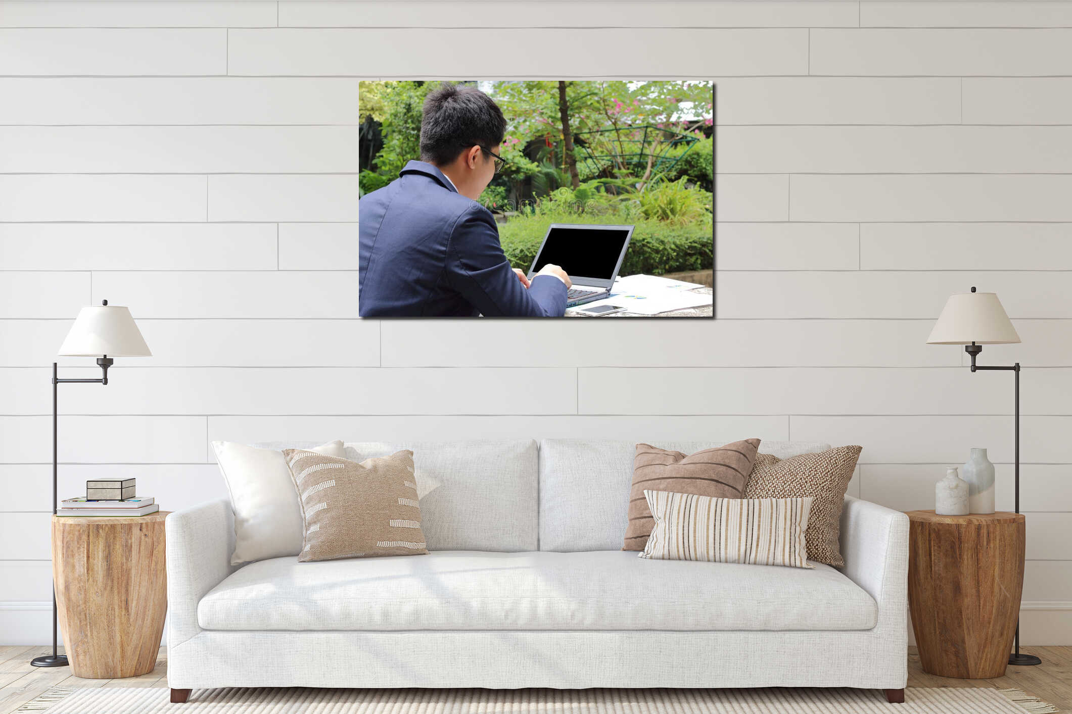 Close up rear view of handsome young business man is working with laptop in public nature background. interior mockup