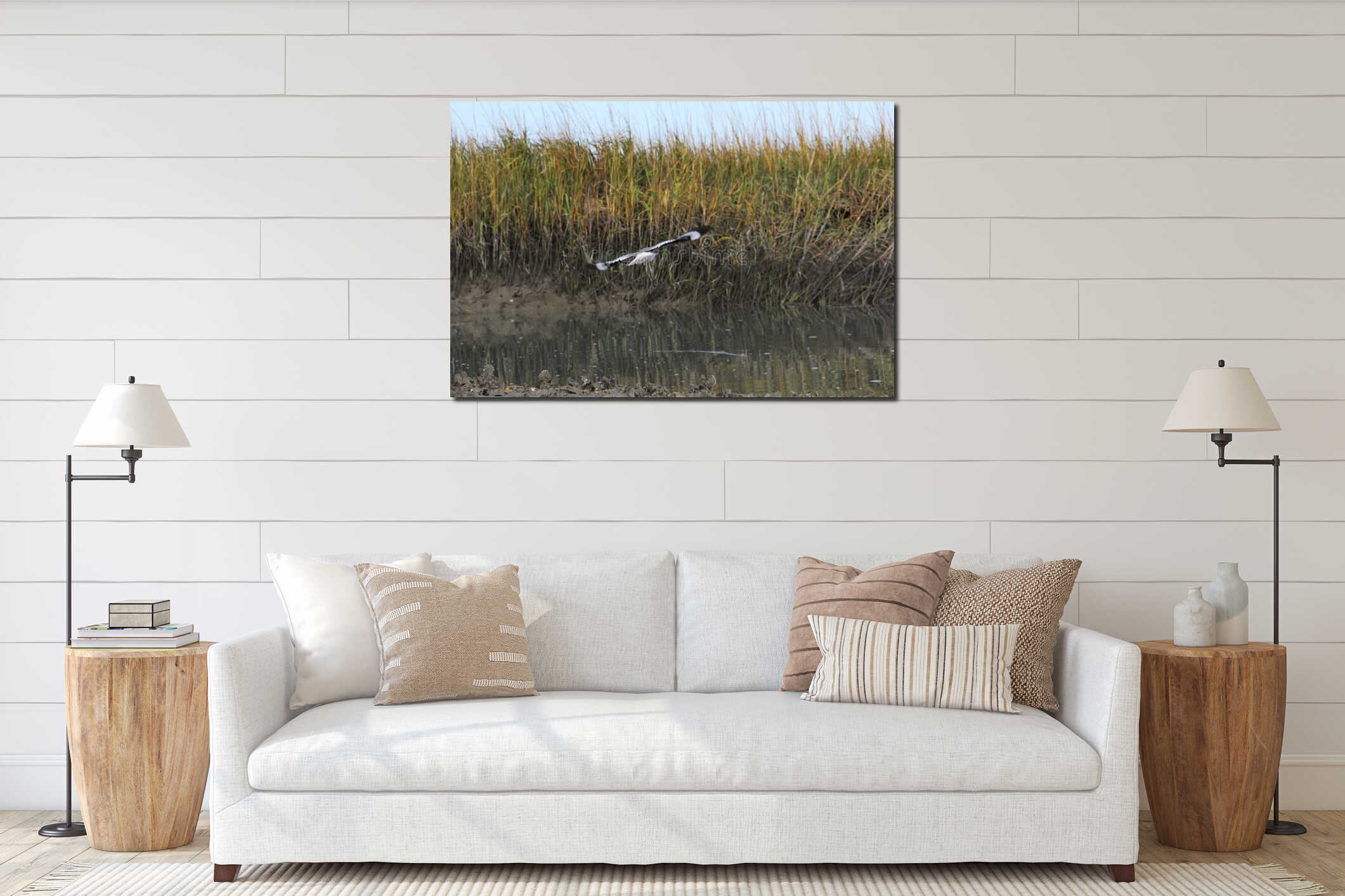 Focus on back of seagull turning while flying with marsh background interior mockup