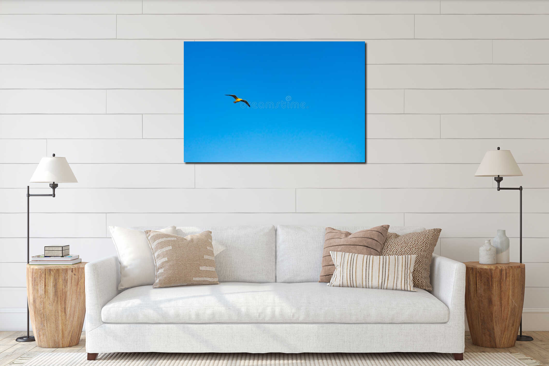 Single seagull flying in front of a bright blue sky interior mockup