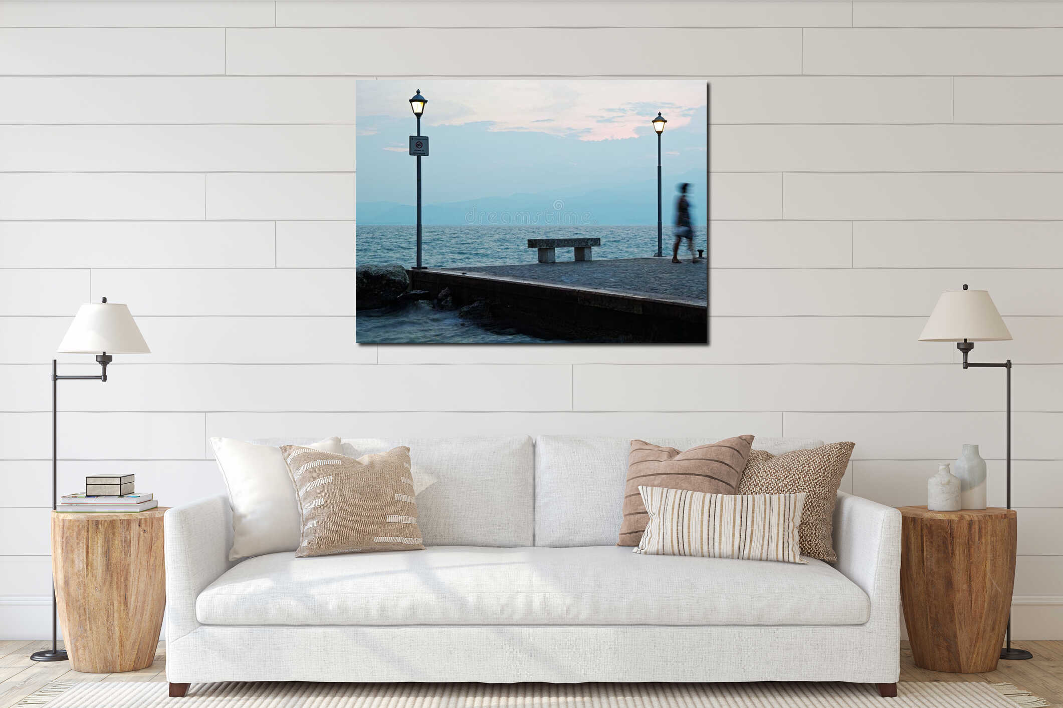 Blurred woman leaving lakeside bench at blue hour by lighted lamp posts interior mockup