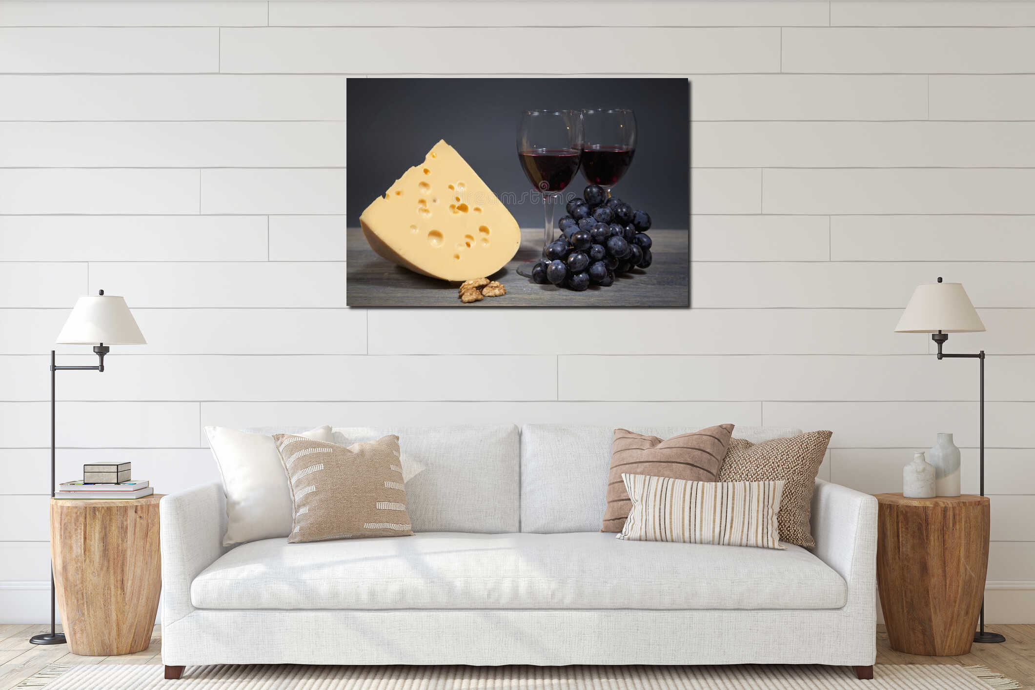 Original composition of gastronomic products. Cheese with a bunch of grapes and two glasses of red wine interior mockup