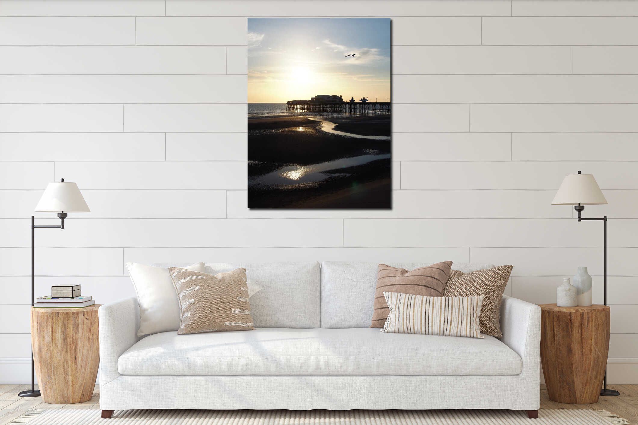 Blackpool north pier a sunset with bright evening sunlight reflected in the water and a seagull flying in blue sky interior mockup