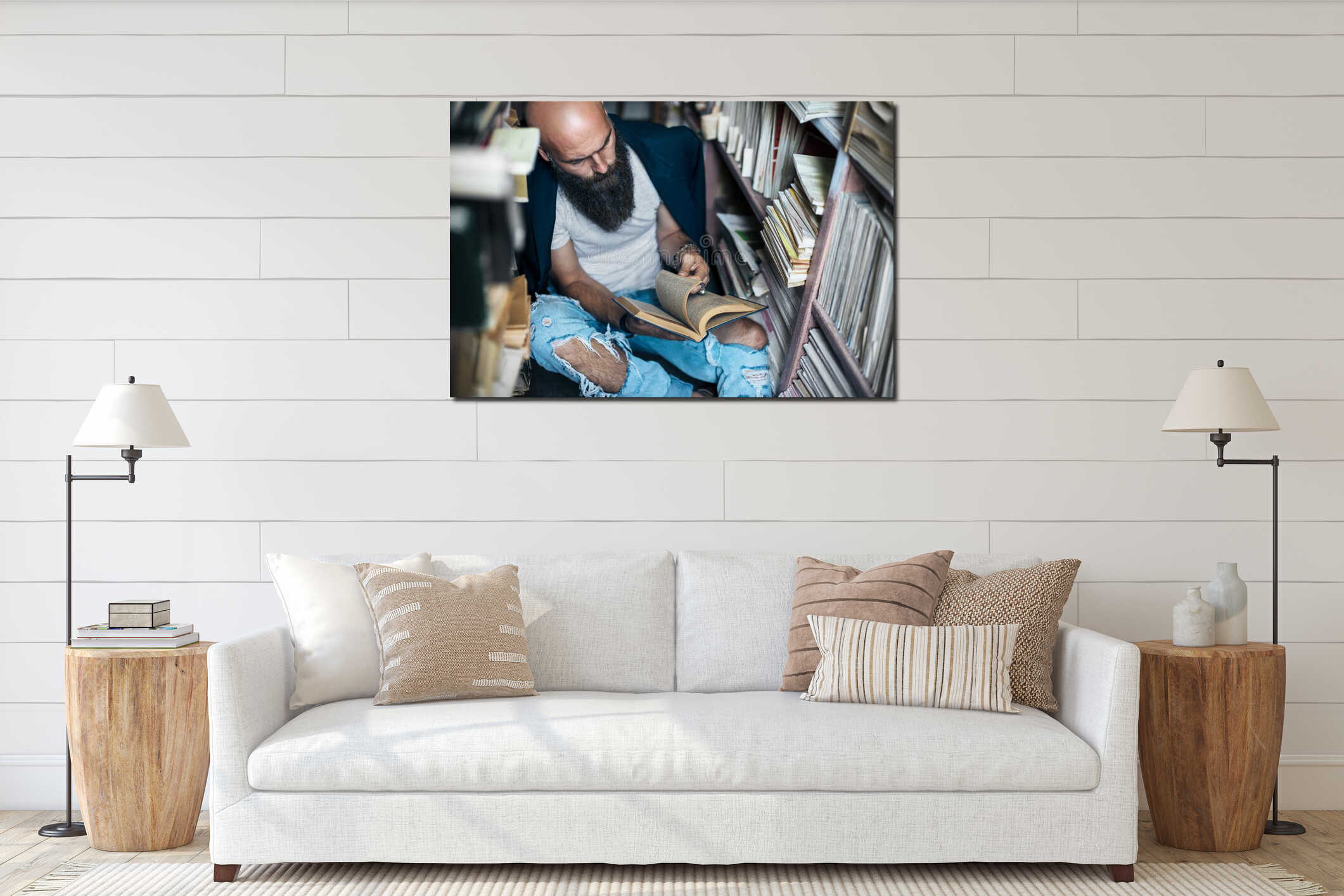 Stylish hipster man reading book sitting on floor in bookstore interior mockup