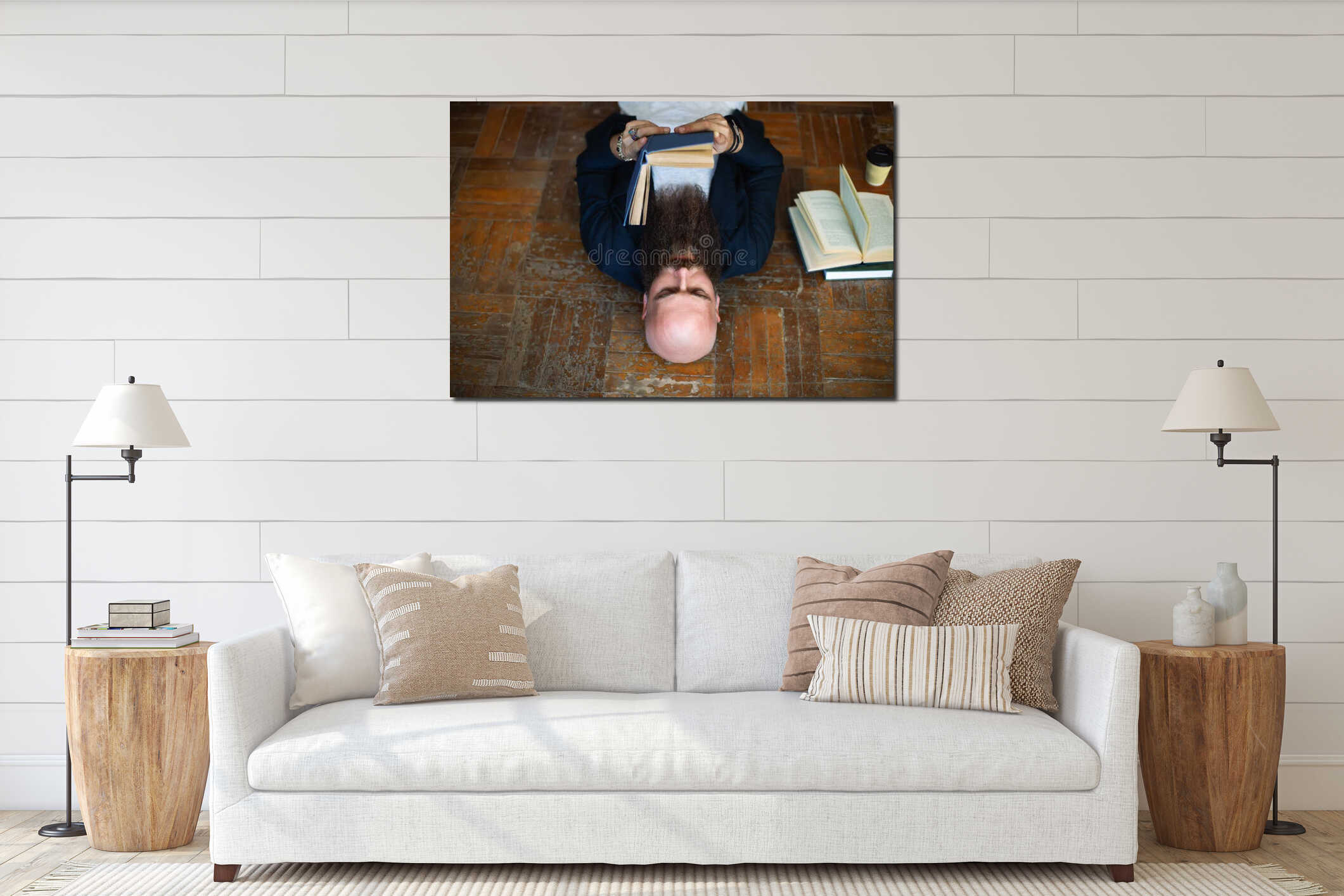 Bald bearded man reading book lies on the floor interior mockup