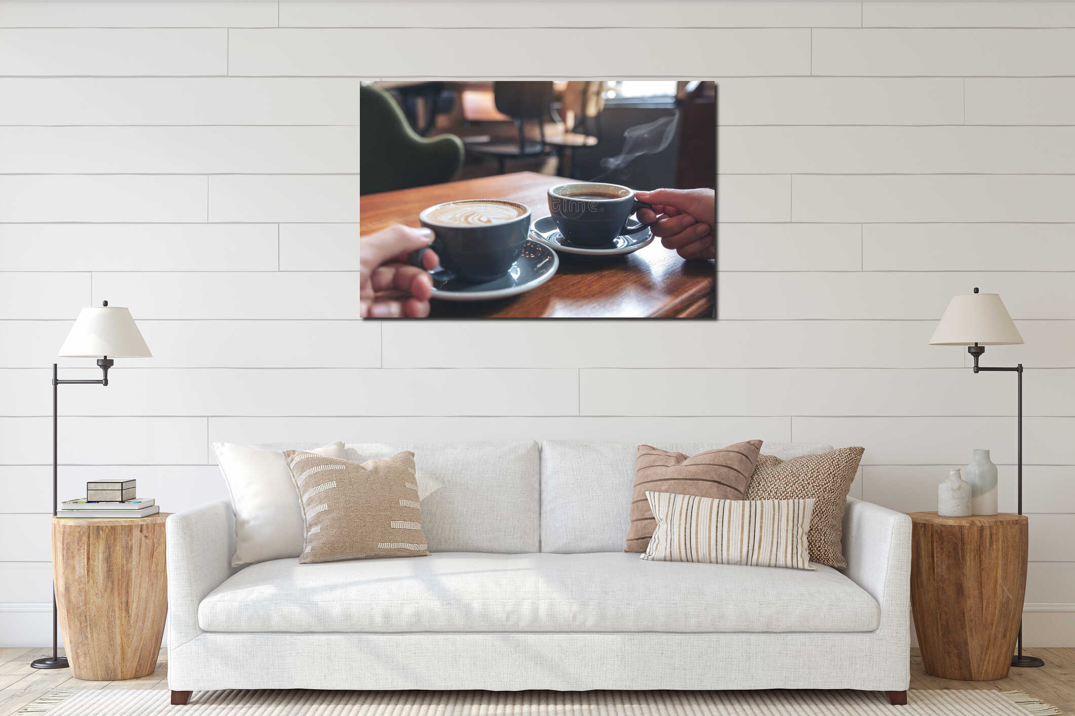 Two people`s hands holding coffee and hot chocolate cups on wooden table in cafe interior mockup