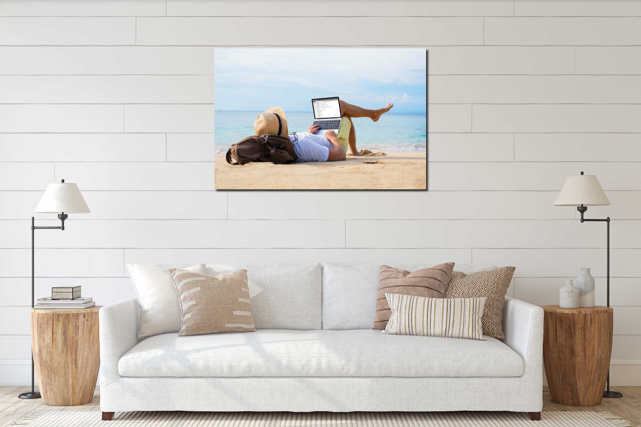 Man reading email on laptop while relaxing on beach interior mockup