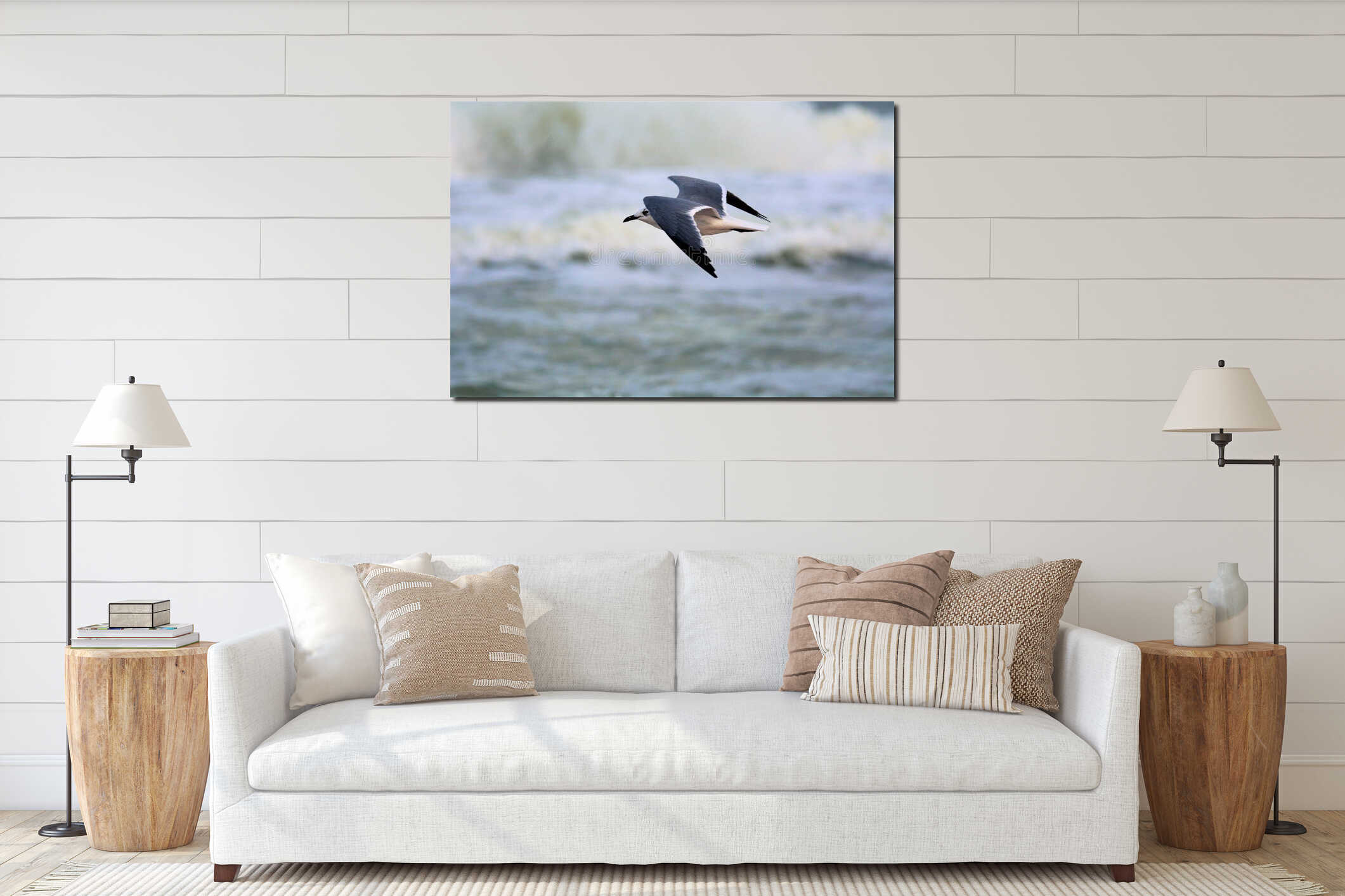 A seagull flies just above the waves along the shoreline fishing for dinner interior mockup