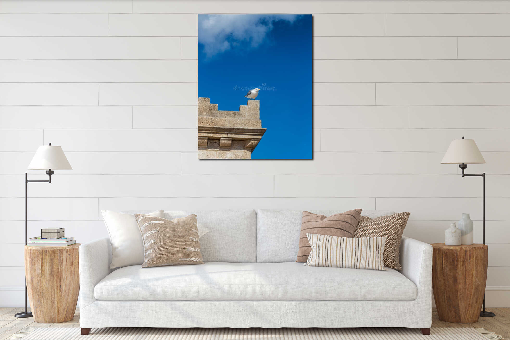 A seagull sits on the edge of the tower against the sky in Barcelona, Spain interior mockup
