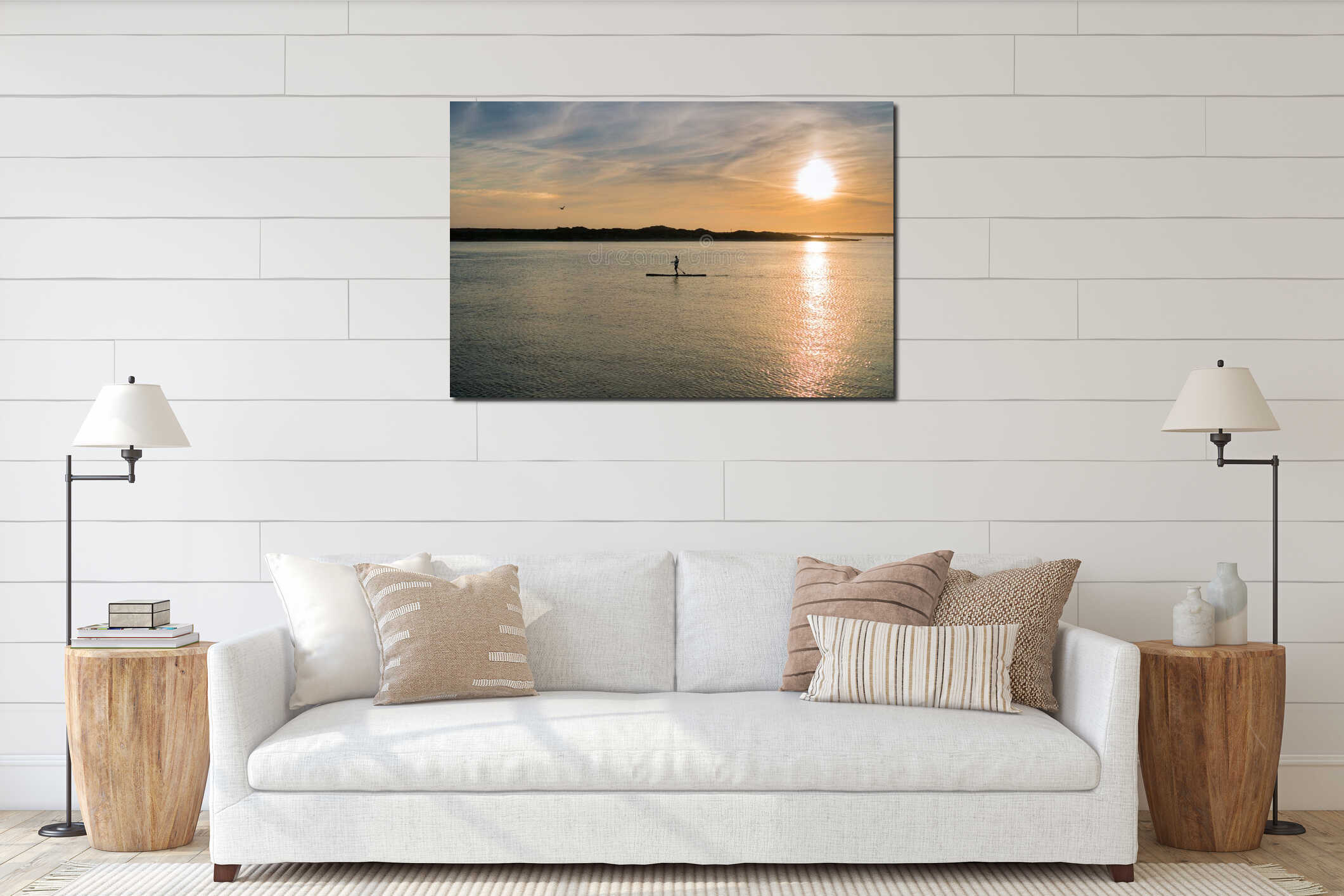 Colorful sunset as seen from the Morro Bay harbor; man paddle boarding towards the shore; California interior mockup
