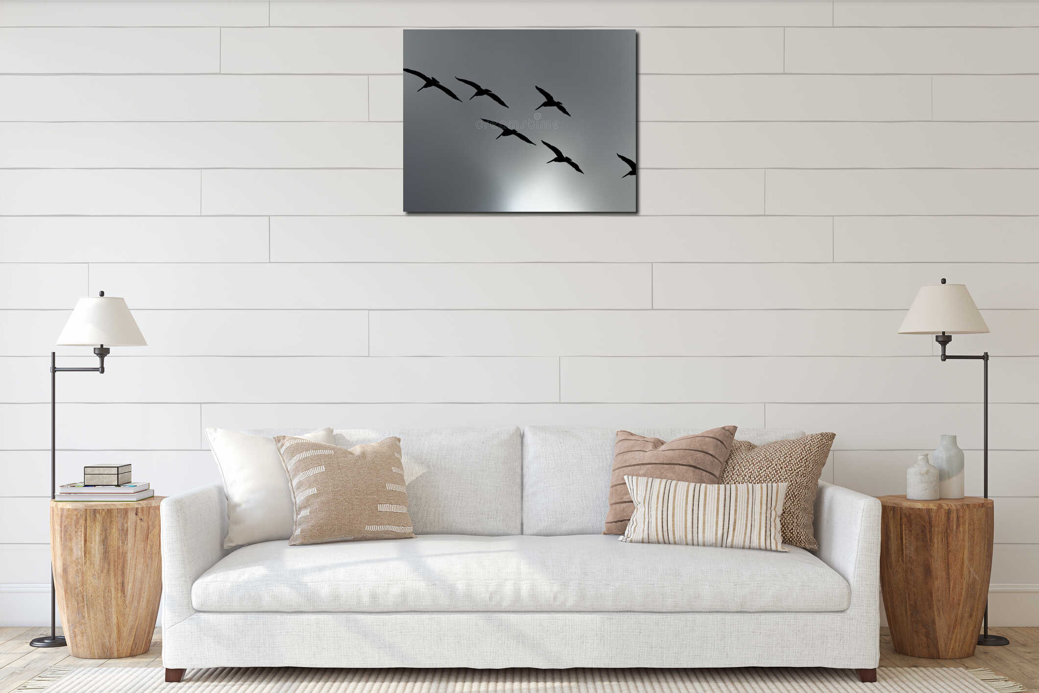 Silhouette of a flock of brown pelicans flying over the gray stormy sky interior mockup