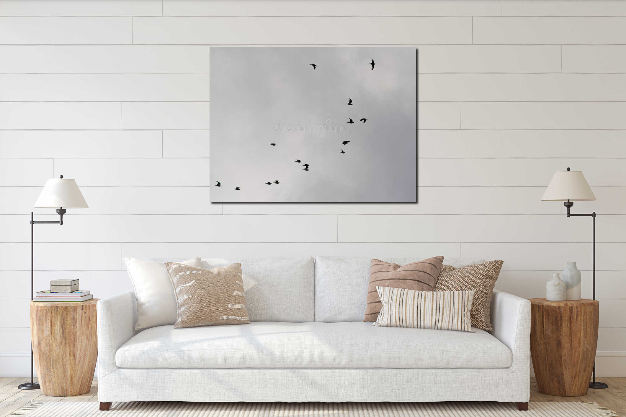 Silhouettes of terns in flight on a cloudy sky interior mockup