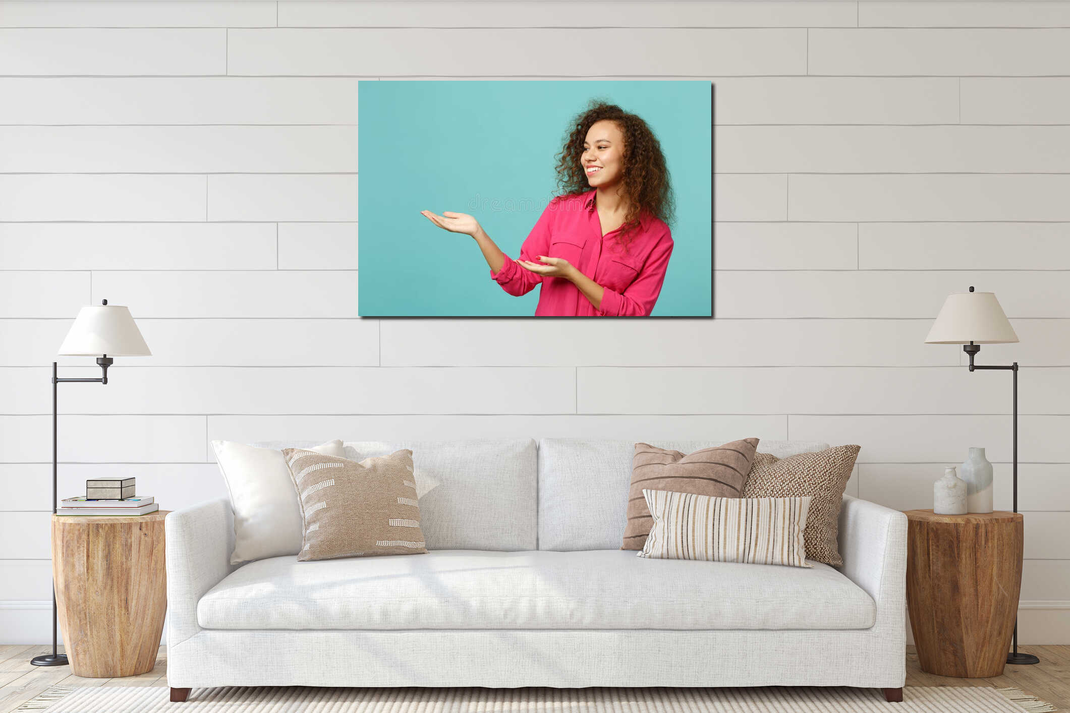 Portrait of funny african girl in pink casual clothes looking pointing hands aside isolated on blue turquoise wall interior mockup
