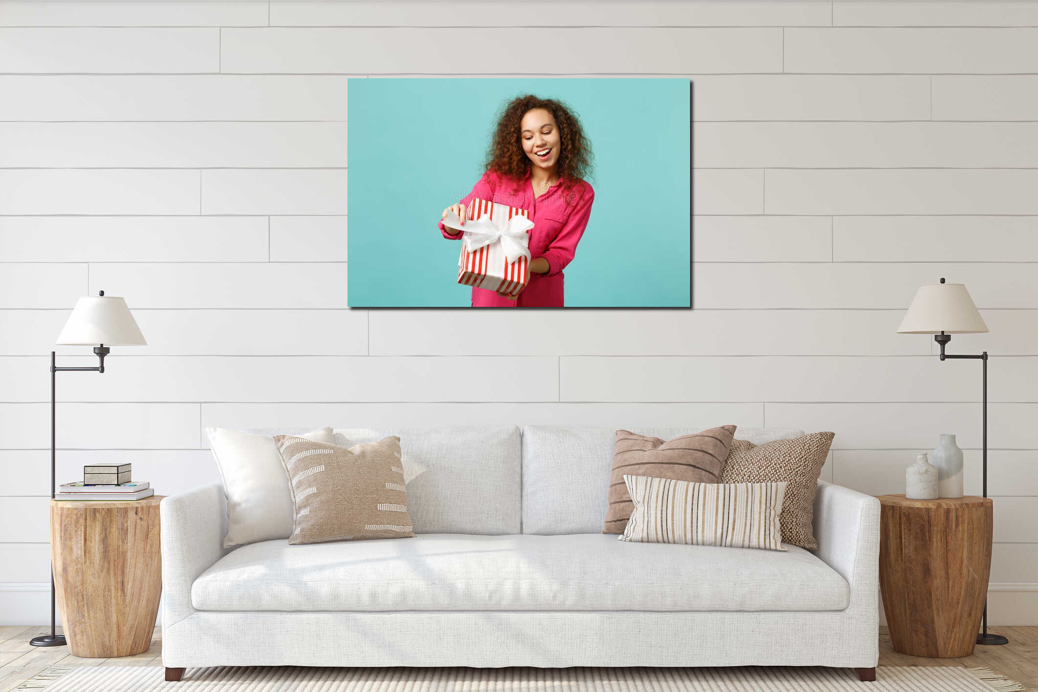 Funny african girl in casual clothes hold red striped present box with gift ribbon isolated on blue turquoise wall interior mockup