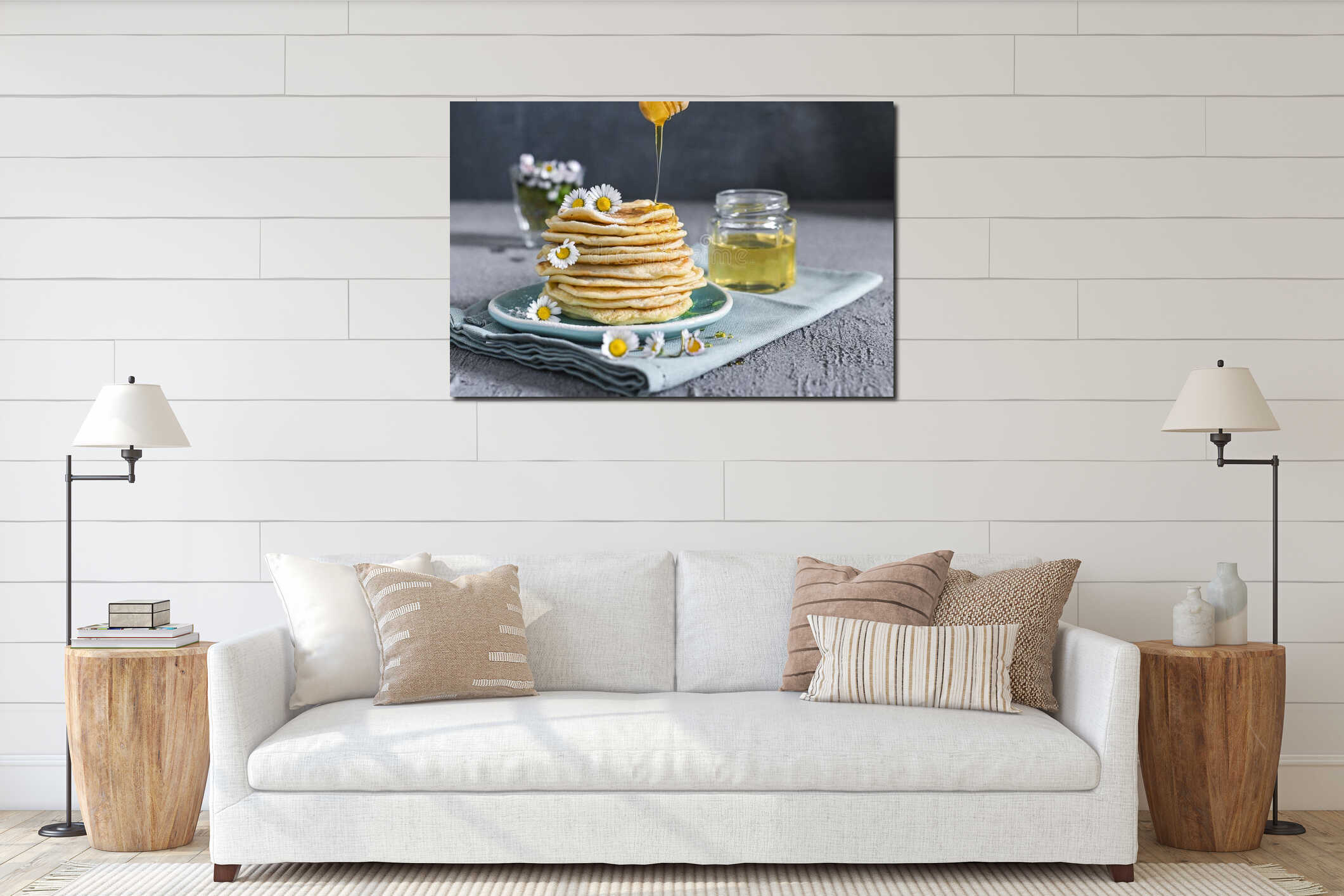 Many small pancakes with honey or syrup. Delicious traditional breakfast. Spring flowers as food styling in photography. Gray interior mockup