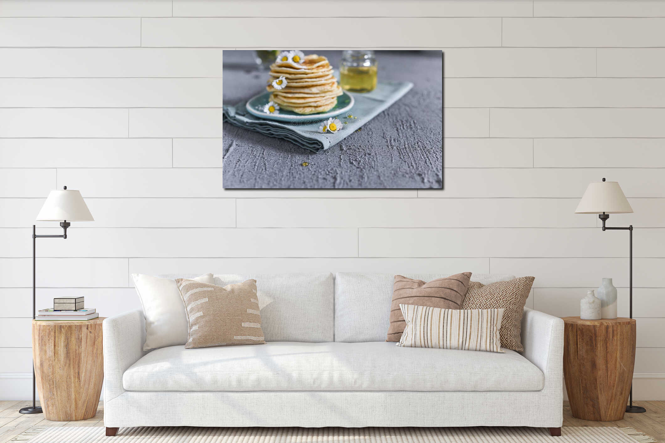 Many small pancakes with honey or syrup. Delicious traditional breakfast. Spring flowers as food styling in photography. Gray interior mockup