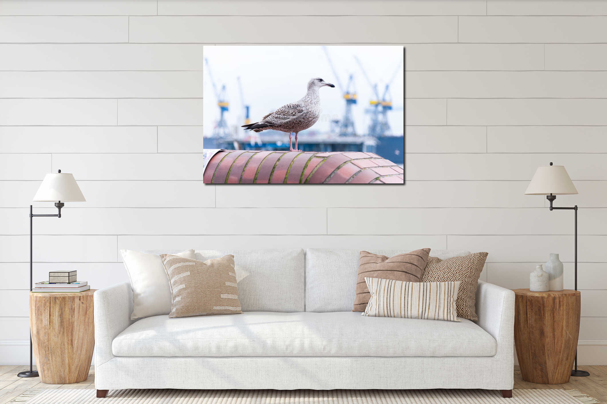 Seagull standing on top of wall with harbor cranes in shallow background interior mockup