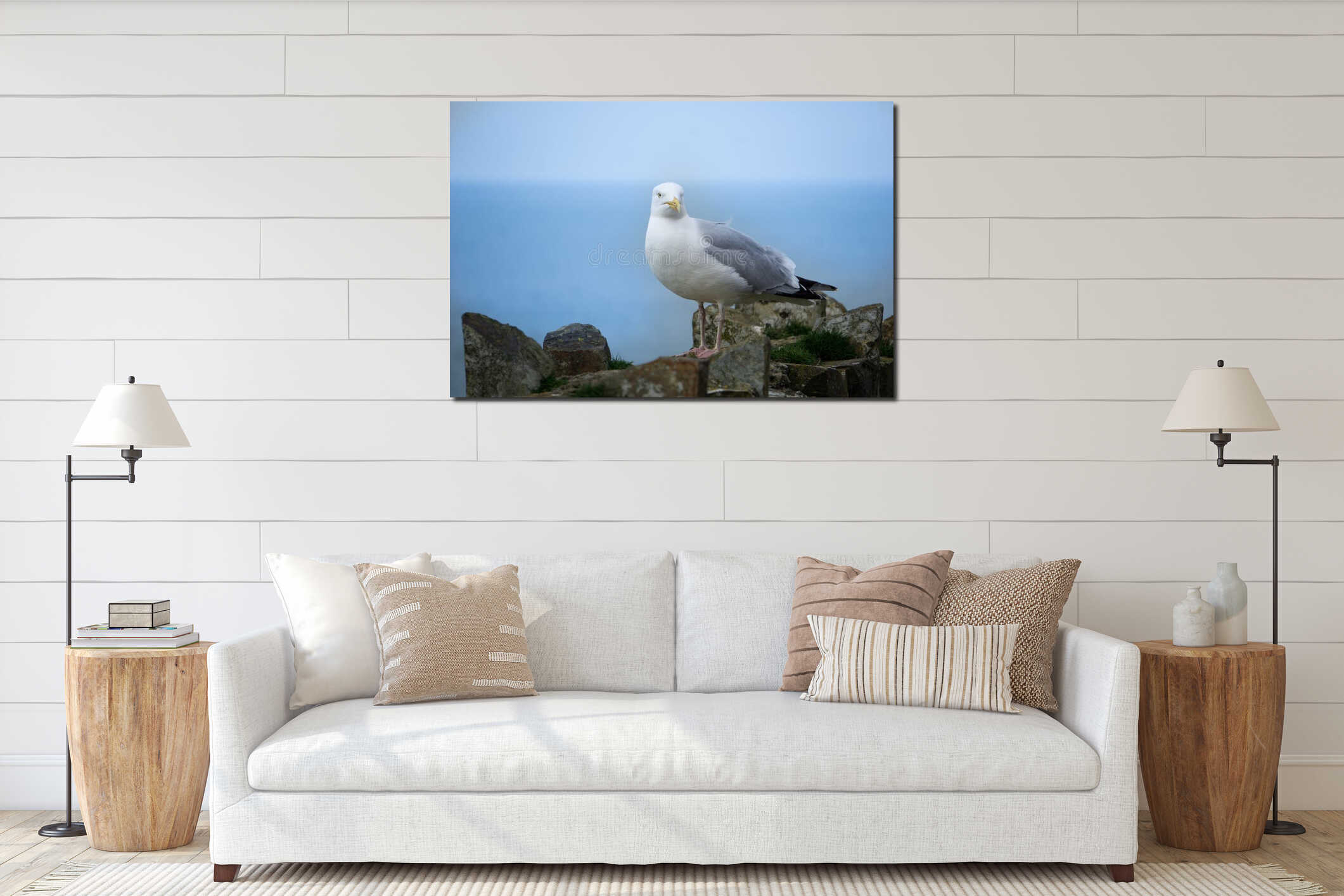 A beautiful white seagull posing on a stone seawall by the ocean in Port Isaac, Cornwall, England. interior mockup