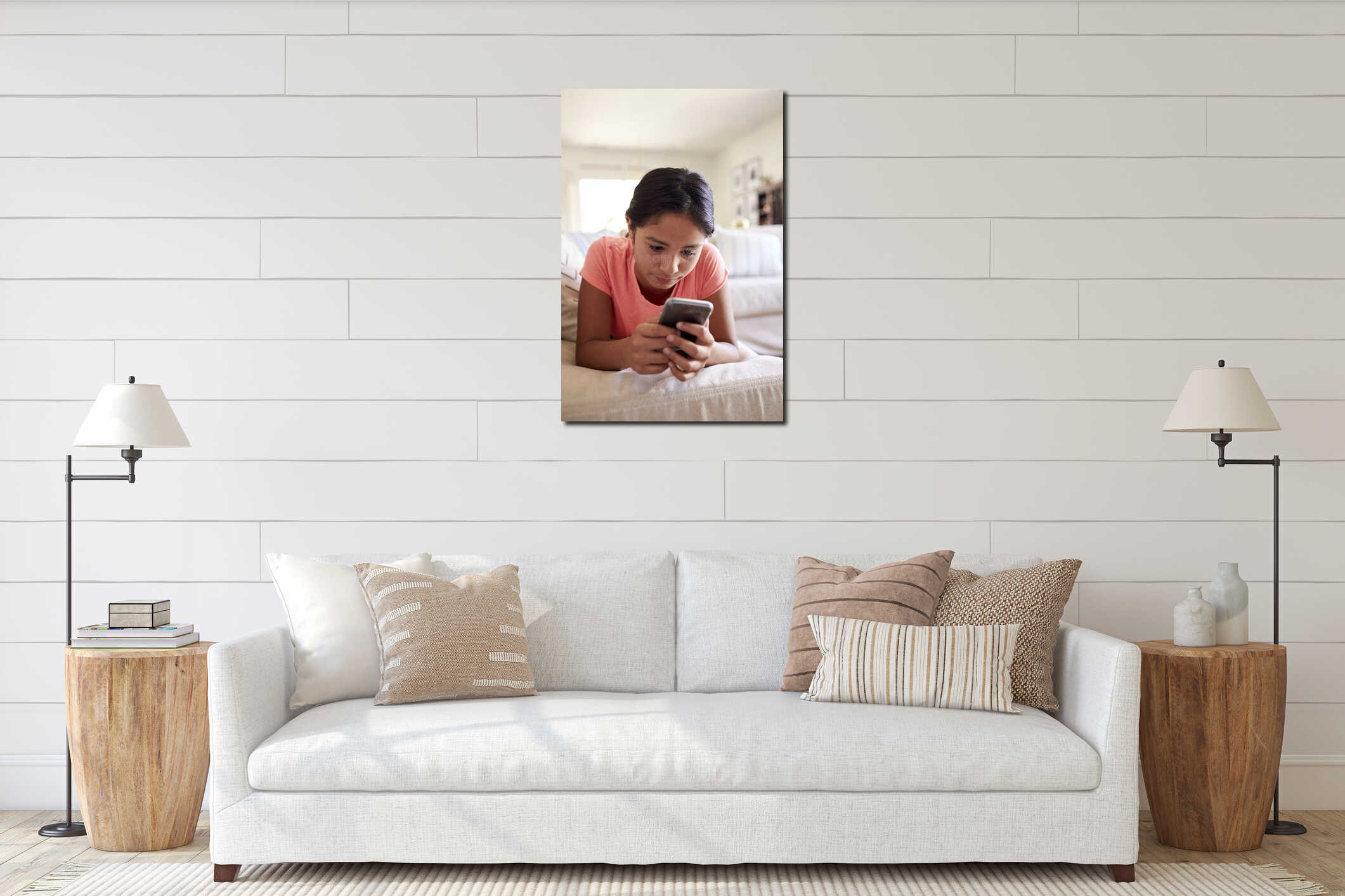 Teenage girl lying on the sofa at home in the living room using smartphone, close up, low angle, close up, vertical interior mockup