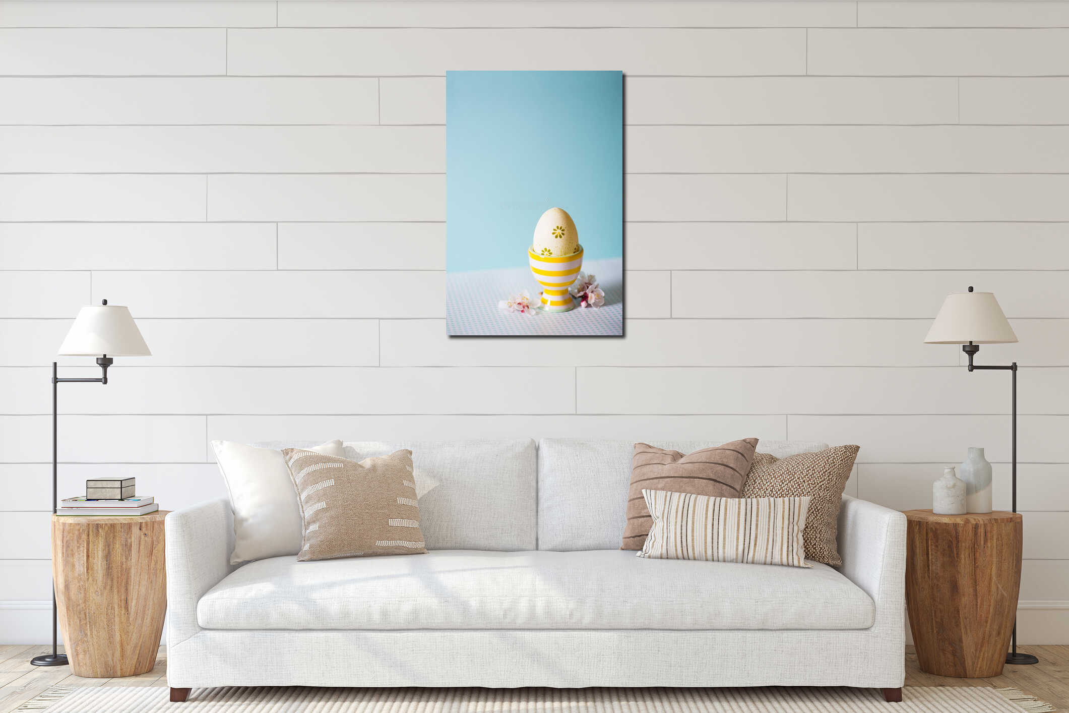 Closeup colorful painted Easter egg in vibrant modern egg stand surrounded by white flowering tree branches on pastel blue interior mockup