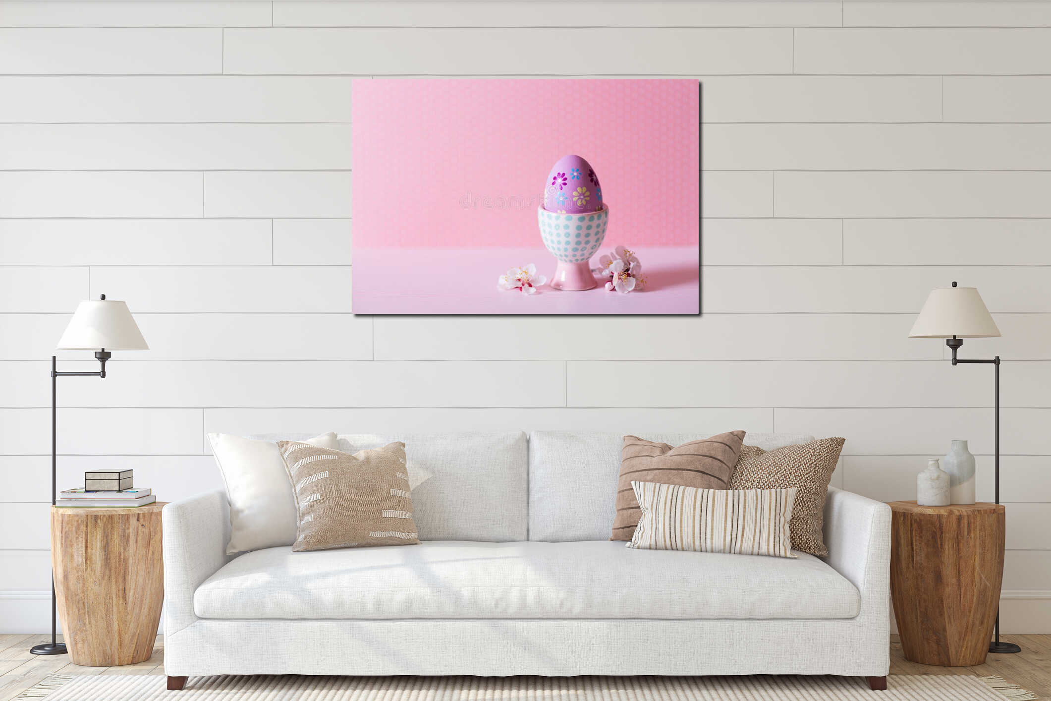 Closeup colorful painted Easter egg in vibrant modern egg stand surrounded by white flowering tree branches on pastel pink interior mockup