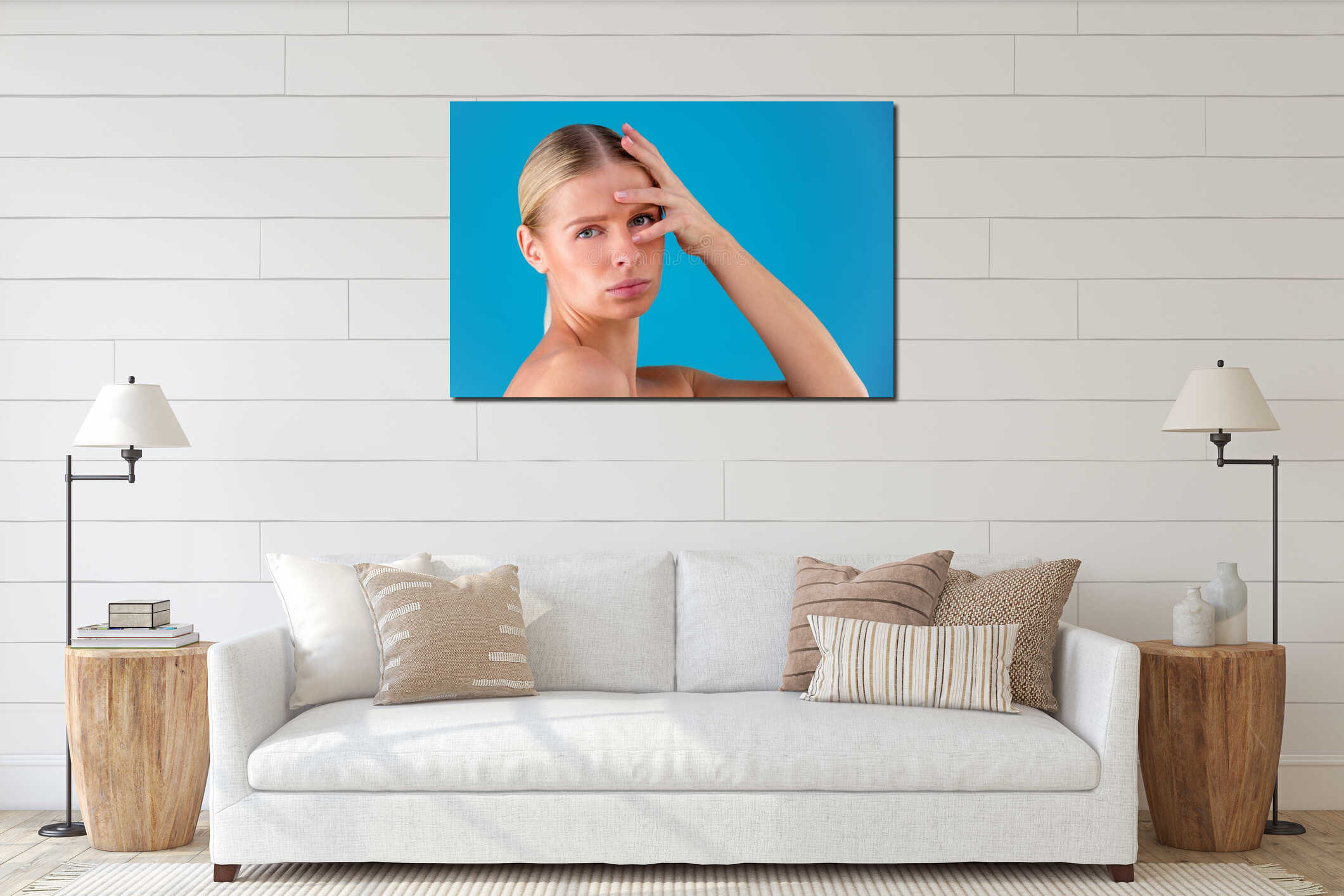 Signs of aging. Portrait of shocked young woman is looking at camera with disappointedly while touching her wrinkles on interior mockup