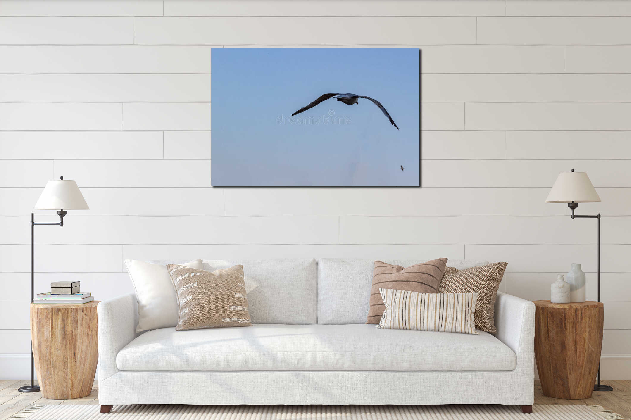 Seagull flying away wings spread on blue sky background from behind interior mockup