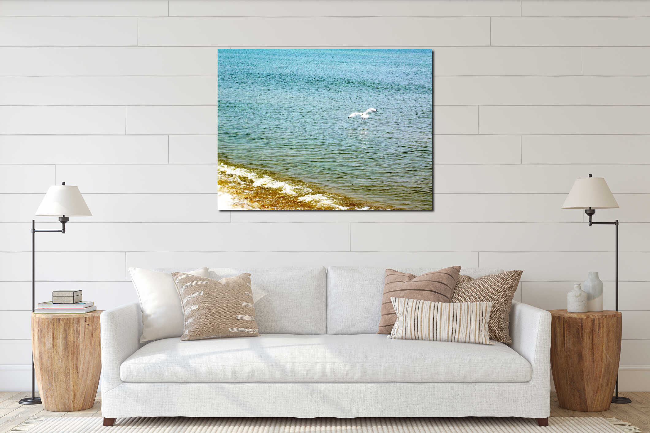 Single flying  seagull  on the background  ripple sea water and coastline interior mockup