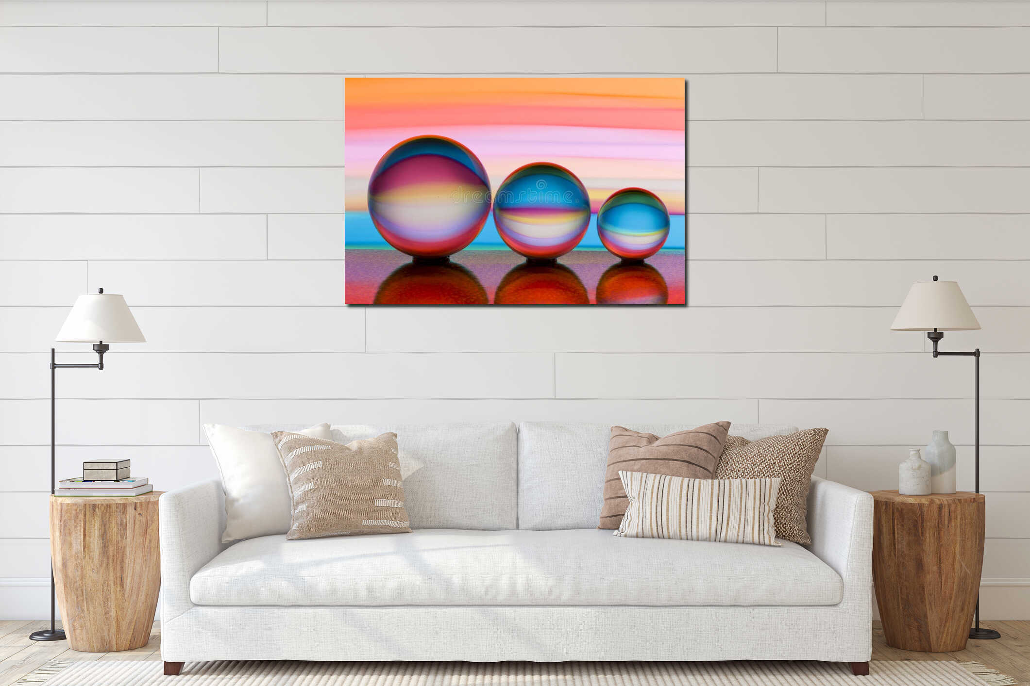 Three glass crystal balls in a row with a rainbow of colorful light painting behind them interior mockup