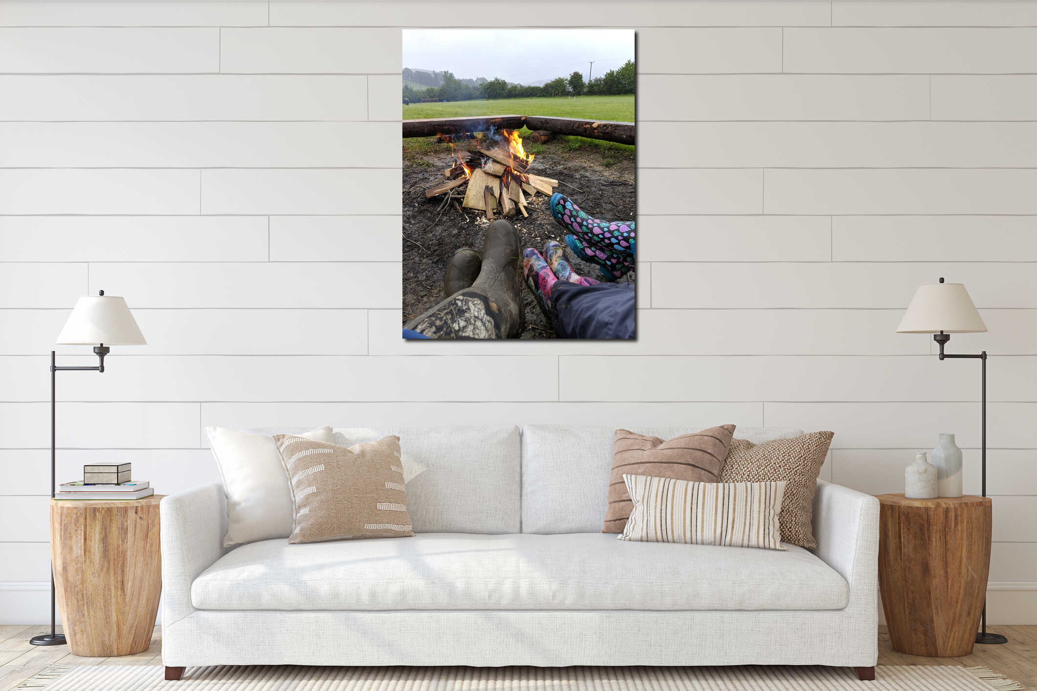 A close up of 3 people in pairs of Wellington boots sitting around a campfire interior mockup
