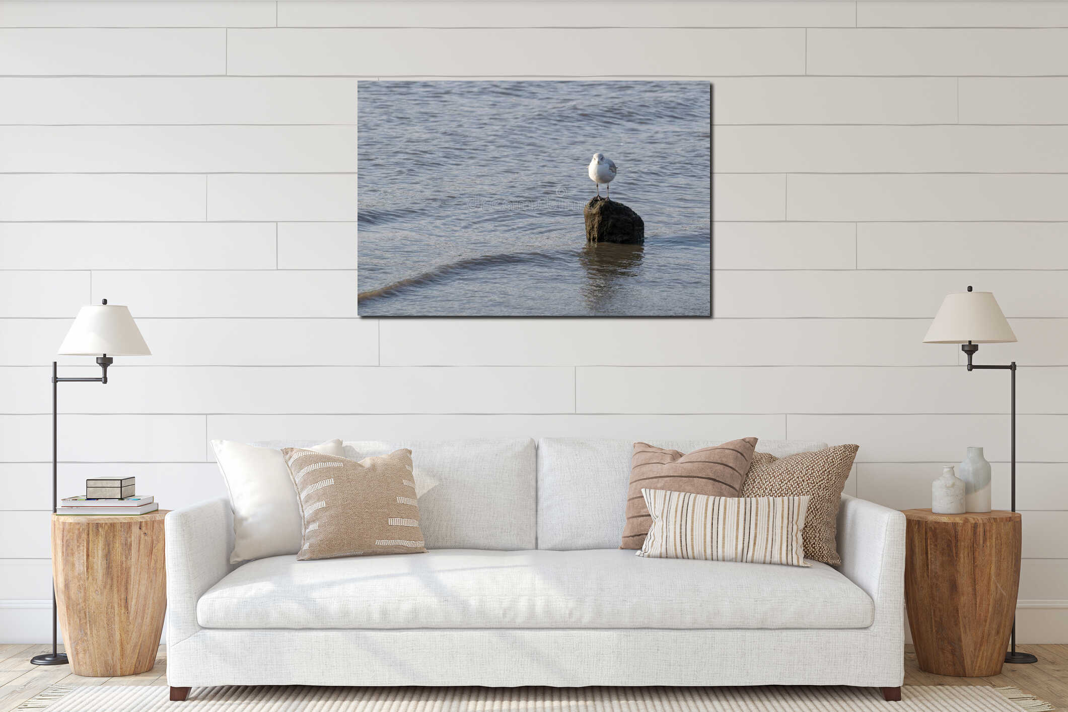 Lone seagull standing on a rock in the shallow waters of the East River interior mockup