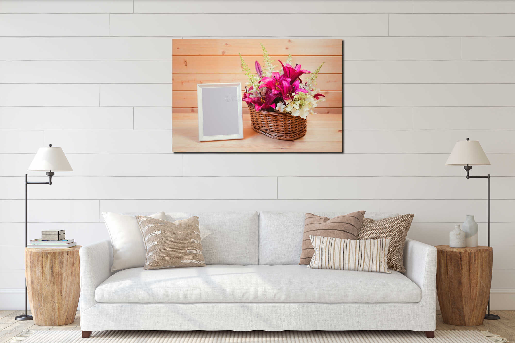 White empty frame and wicker basket with purple lilies and white astilbe and hydrangea flowers on wooden table interior mockup