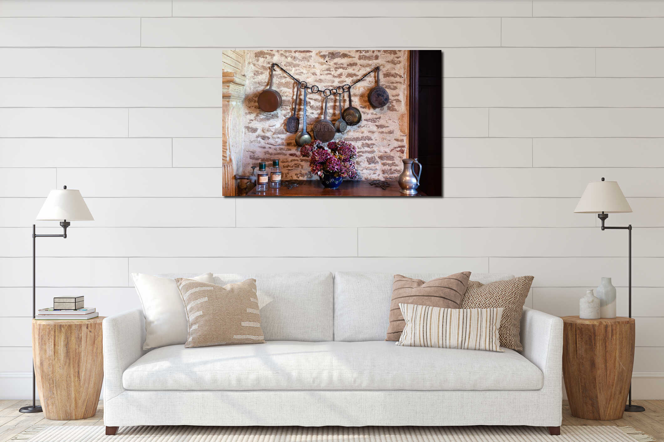 Closeup antique antique aged copper utensils, pots, pans hanging on stone brick wall at home, decoration, flowers in vase, interior mockup