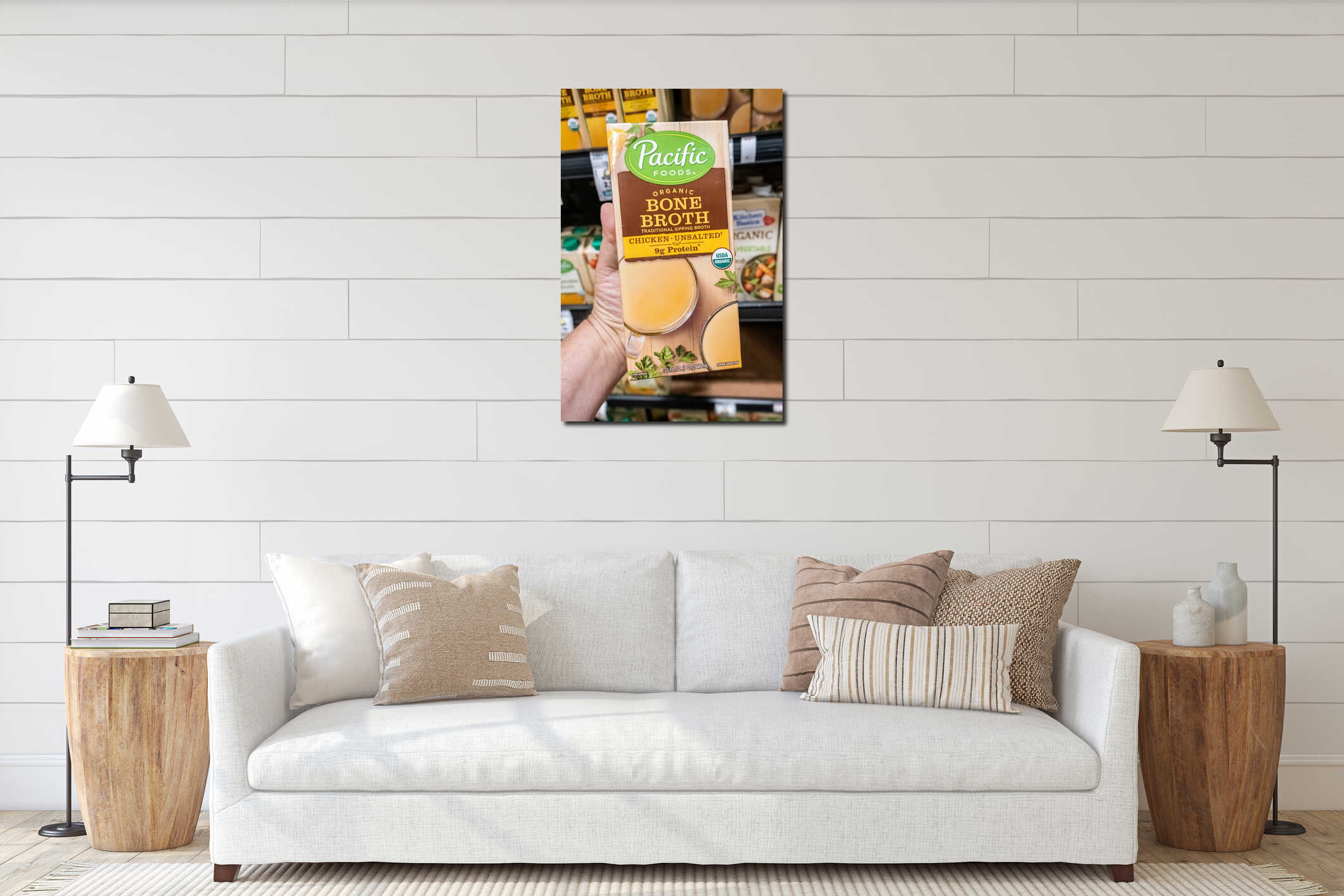 Shoppers hand holding a package of Pacific foods brand organic unsalted chicken bone broth interior mockup