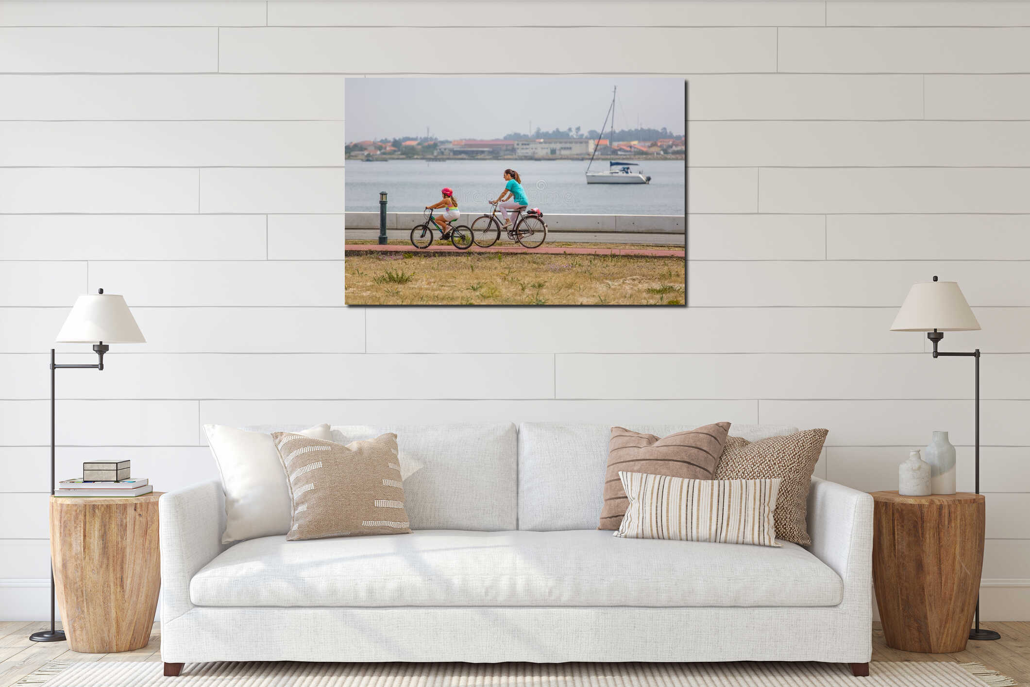 View of a mother and daughter riding a bicycle on a bike path by the river with boat interior mockup