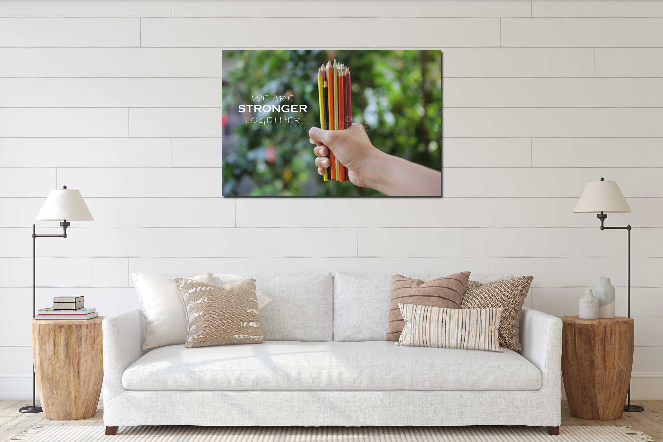 Inspiratinal motivational quote - We are stronger together. With young woman hand holds bunch of pencil colored and blurry green. interior mockup