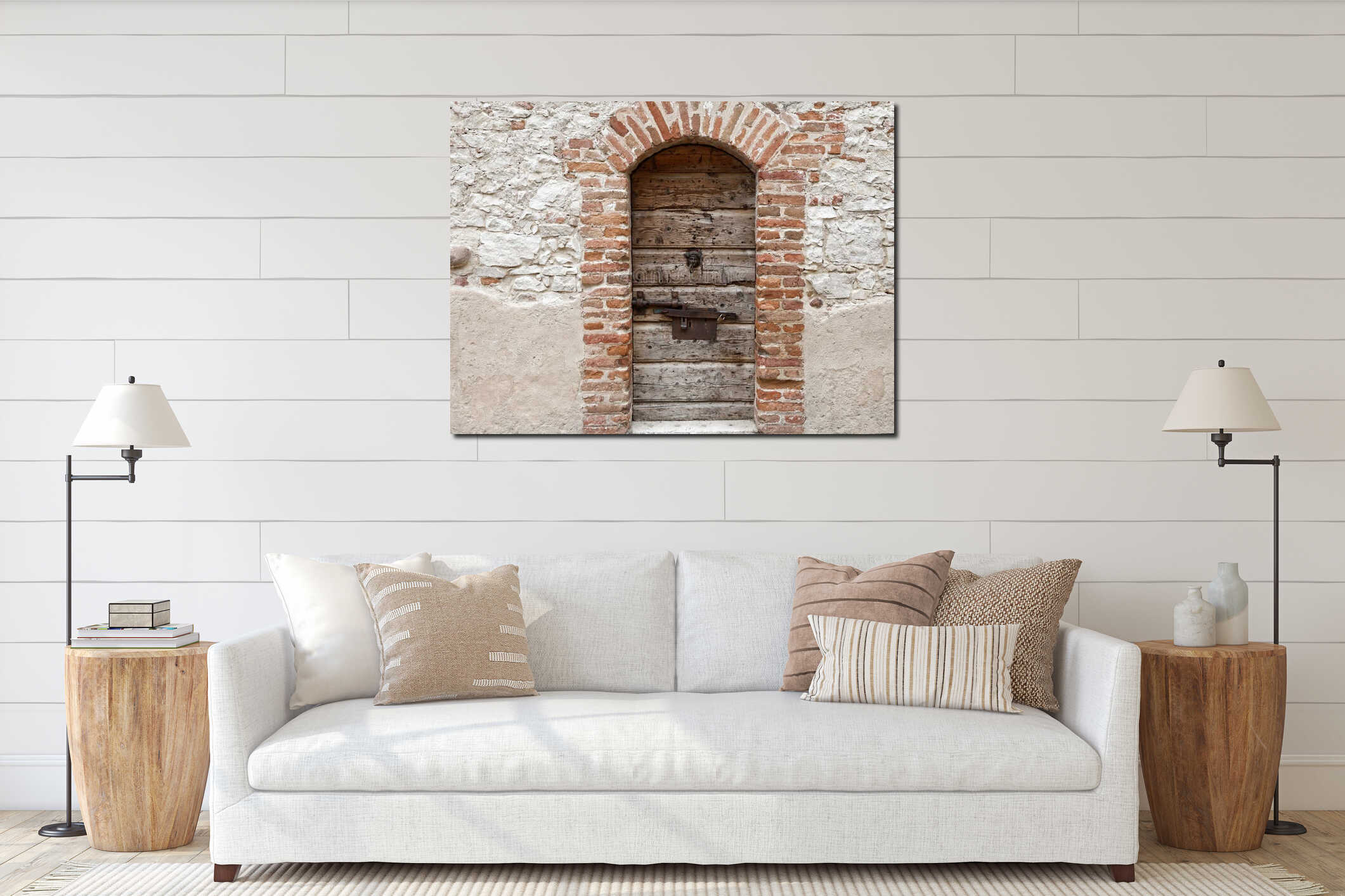 Old brick masonry arch with weathered wooden door in thick stone wall interior mockup