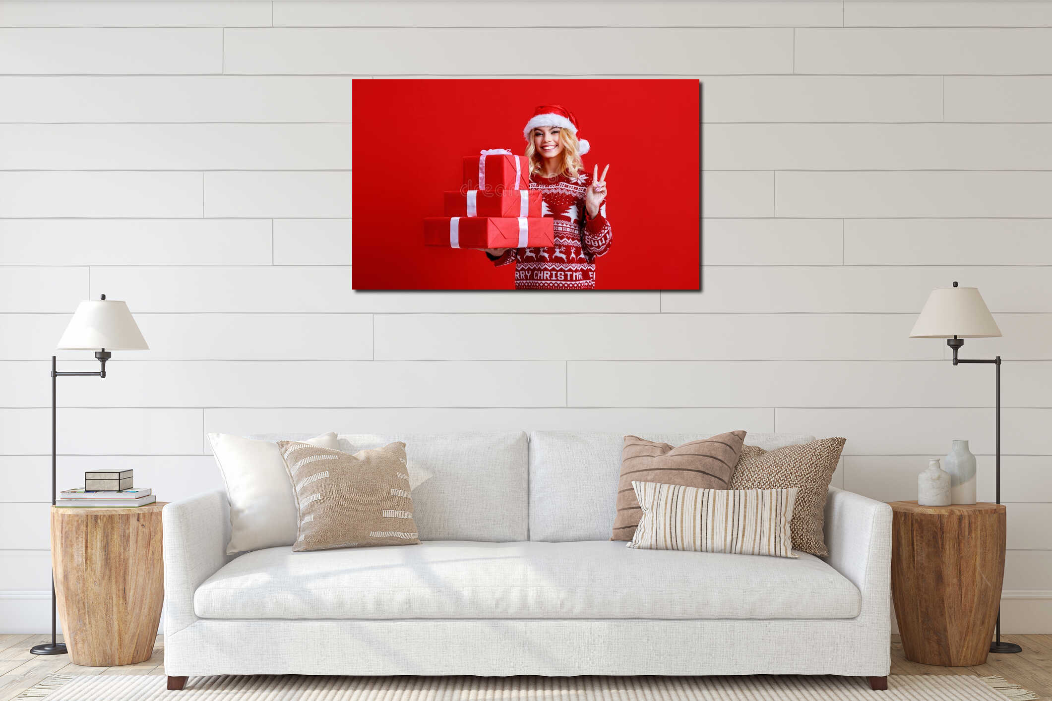 Happy young cheerful girl laughs and jumps in christmas hat and with  gift on  red   background interior mockup