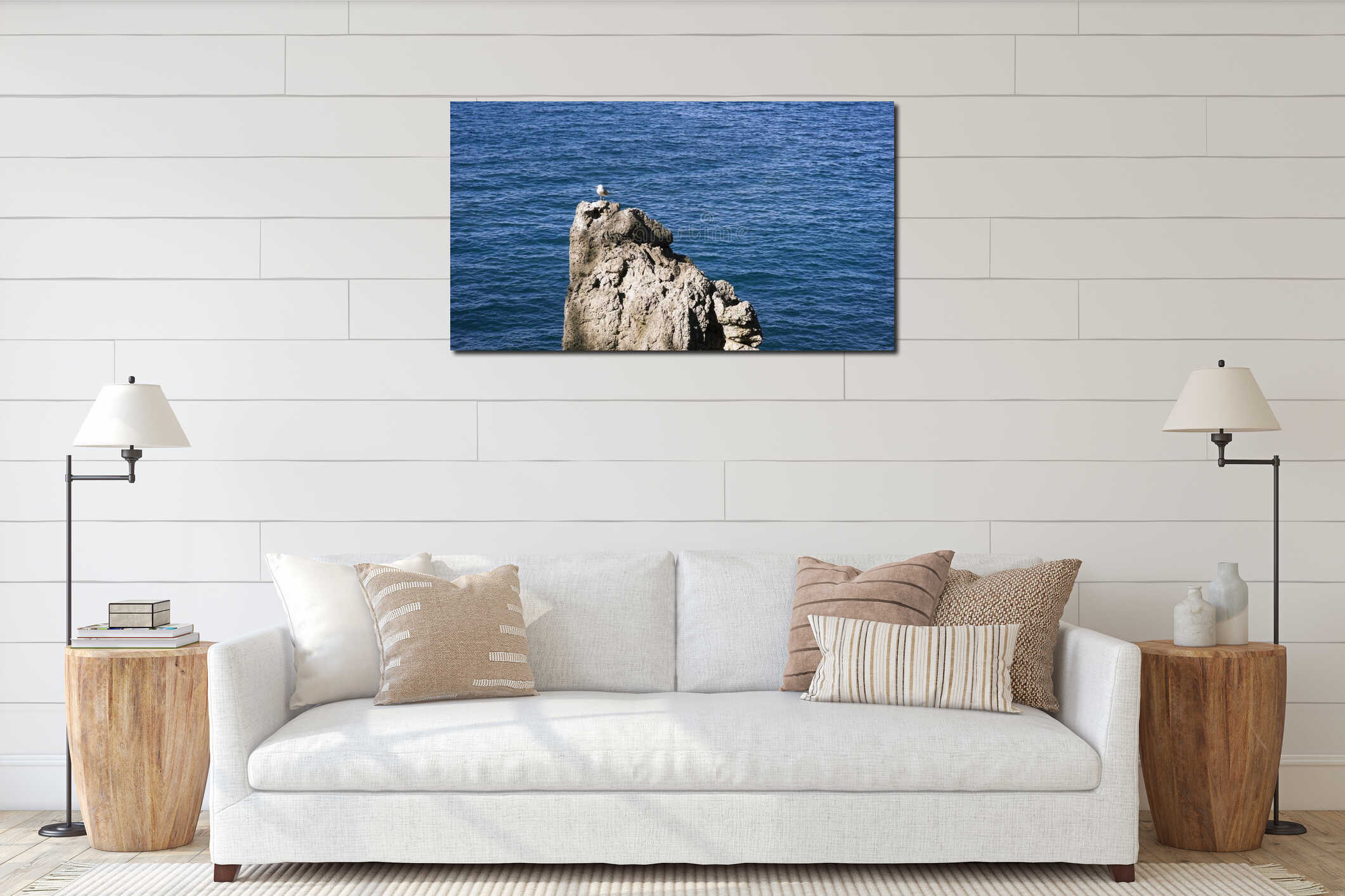 Beautiful seascape with a lonely seagull standing on a rock by the sea. Art. Small white bird standing on a stony interior mockup