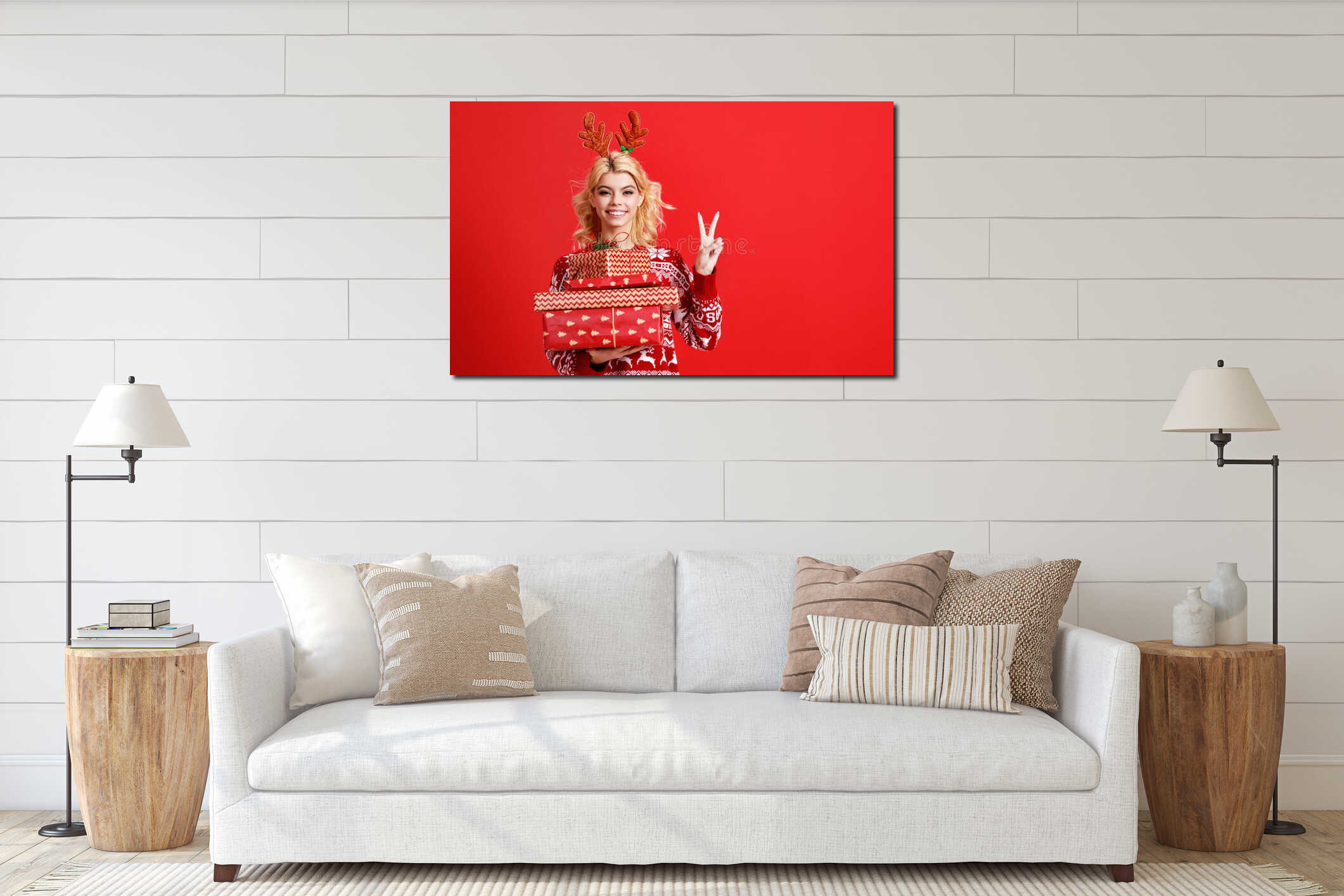 Happy young cheerful girl laughs and jumps in christmas hat and with  gift on  red   background interior mockup