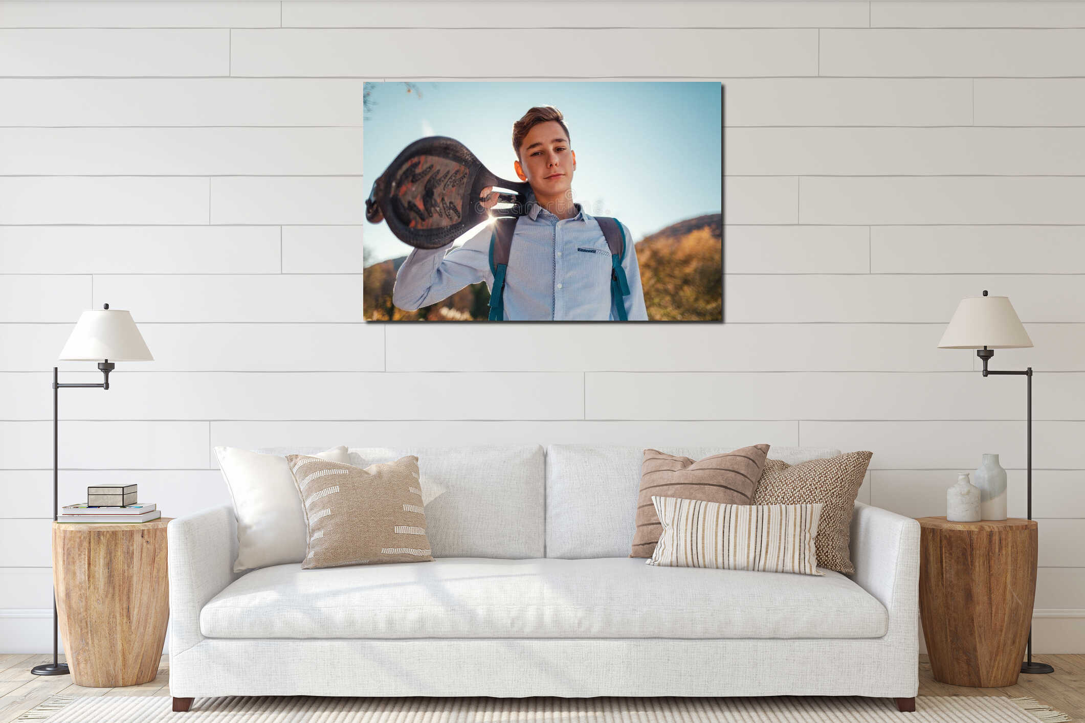 Portrait of a Teen boy holding a skateboard. Mountains and sky in the background interior mockup