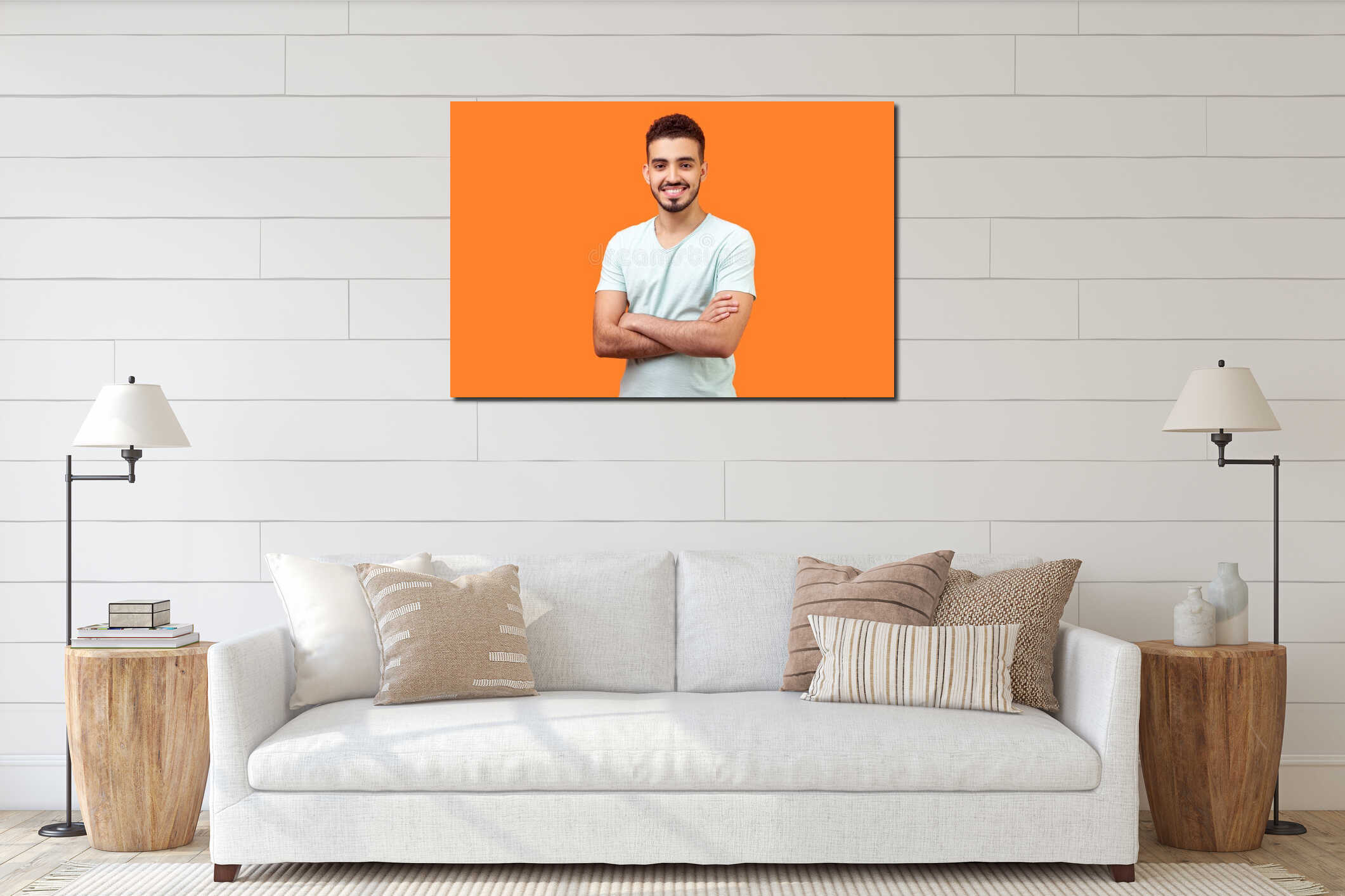 Portrait of positive handsome brunette man standing with crossed hands. indoor studio shot isolated on orange background interior mockup
