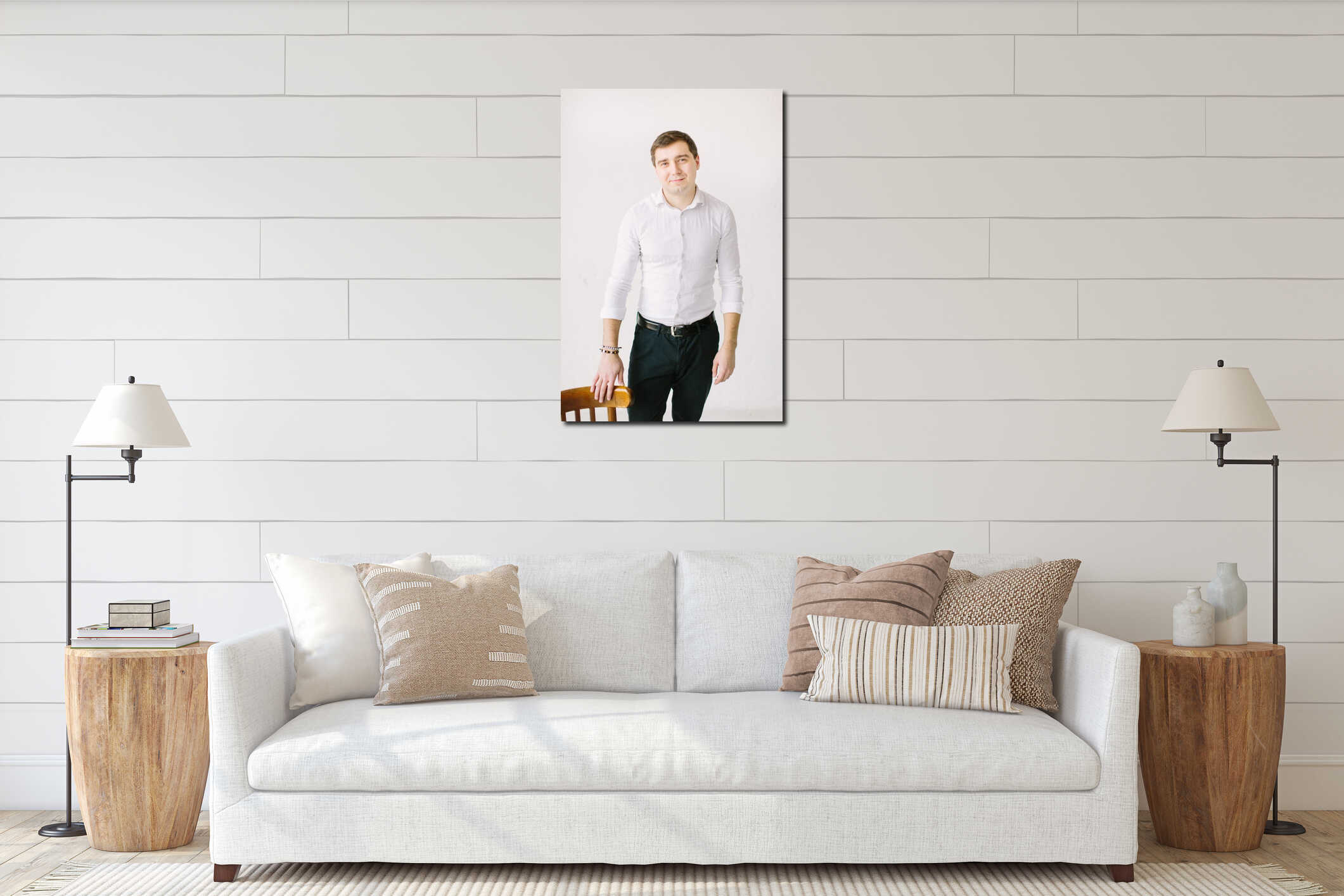 Elegant handsome groom in white skirt standing in white room posing with the wooden chair, wedding preparation. interior mockup