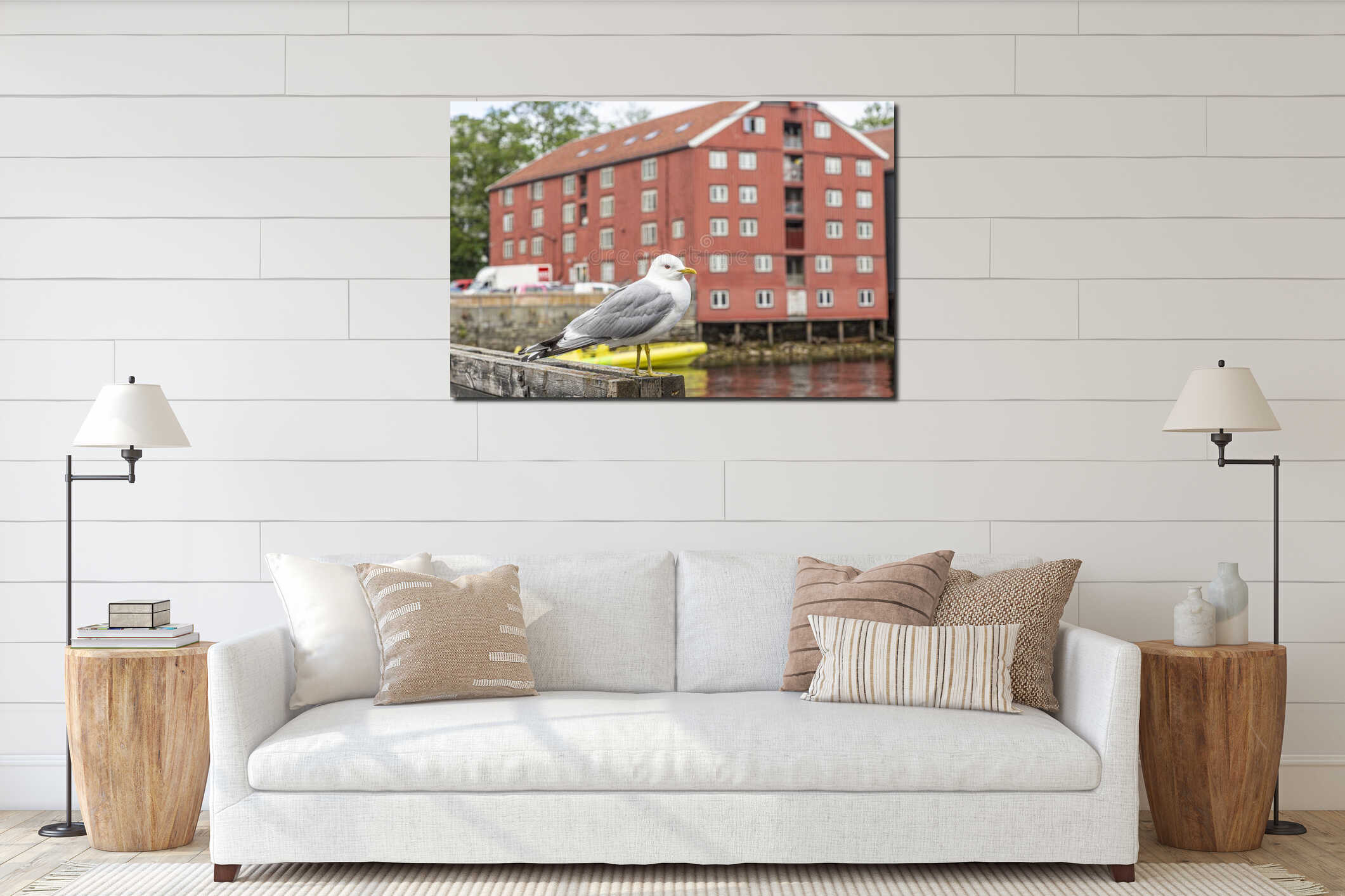 Portrait of seagull sitting in front of a red colored house during daytime interior mockup
