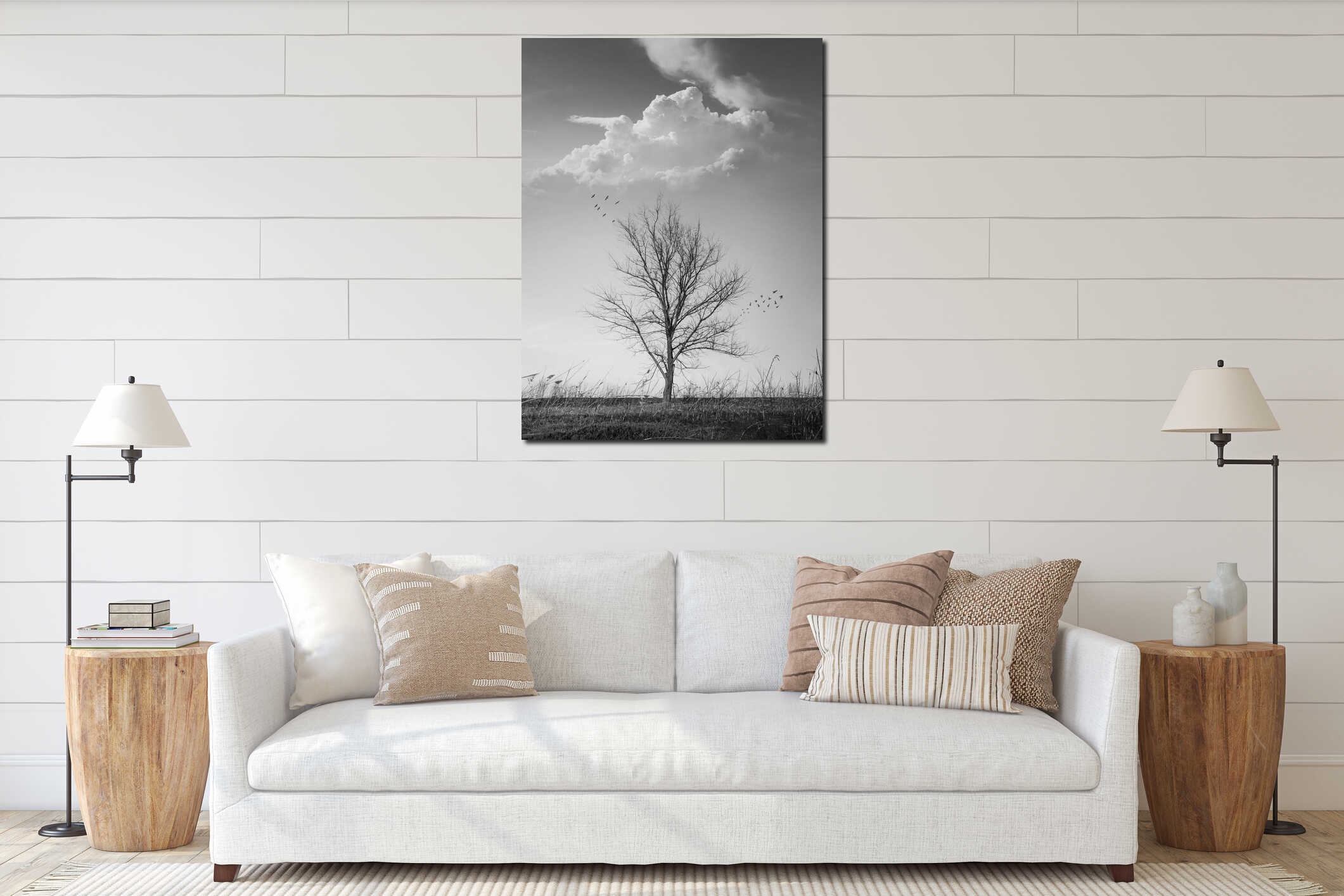 Dramatic black and white vertical photo of a barren lone tree on the autumn meadow and flock of birds flying away. Conceptual interior mockup