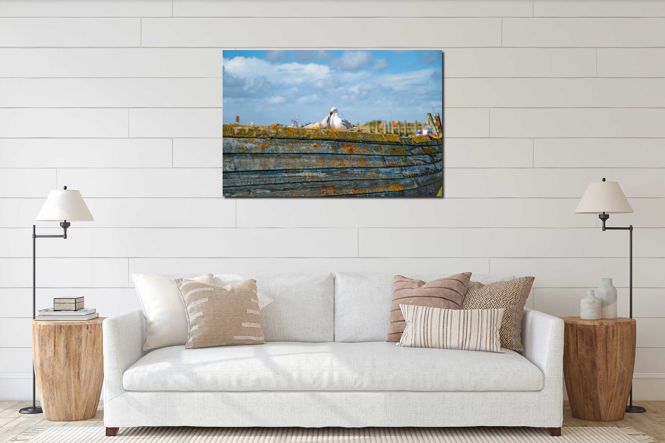 Rye Harbour, East Sussex, England. Old weathered boat sitting in the mud at low tide with seagull caring adult and juvenile interior mockup
