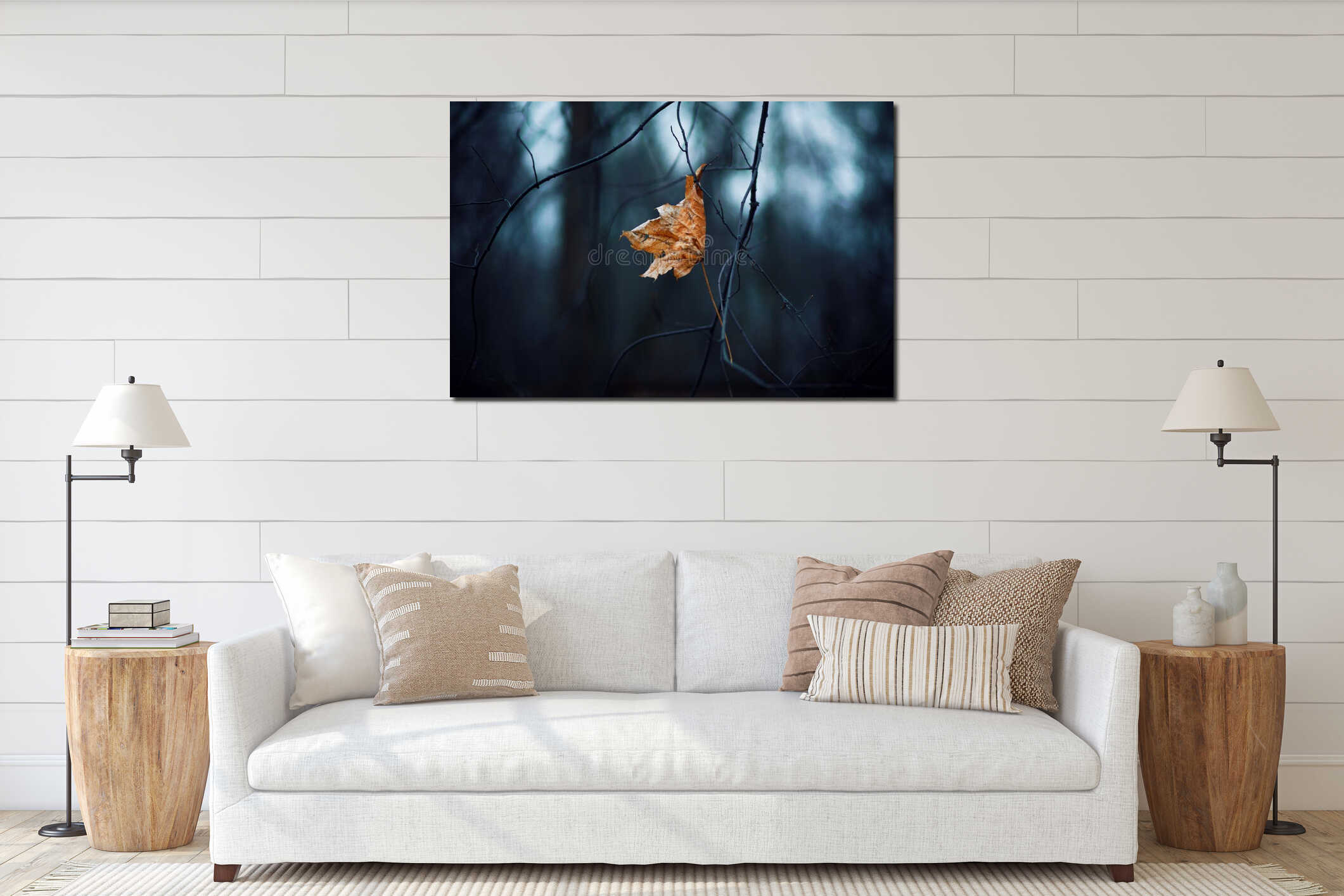 In the gloomy forest, a dry, lone maple leaf hangs on the curved, thin branches interior mockup