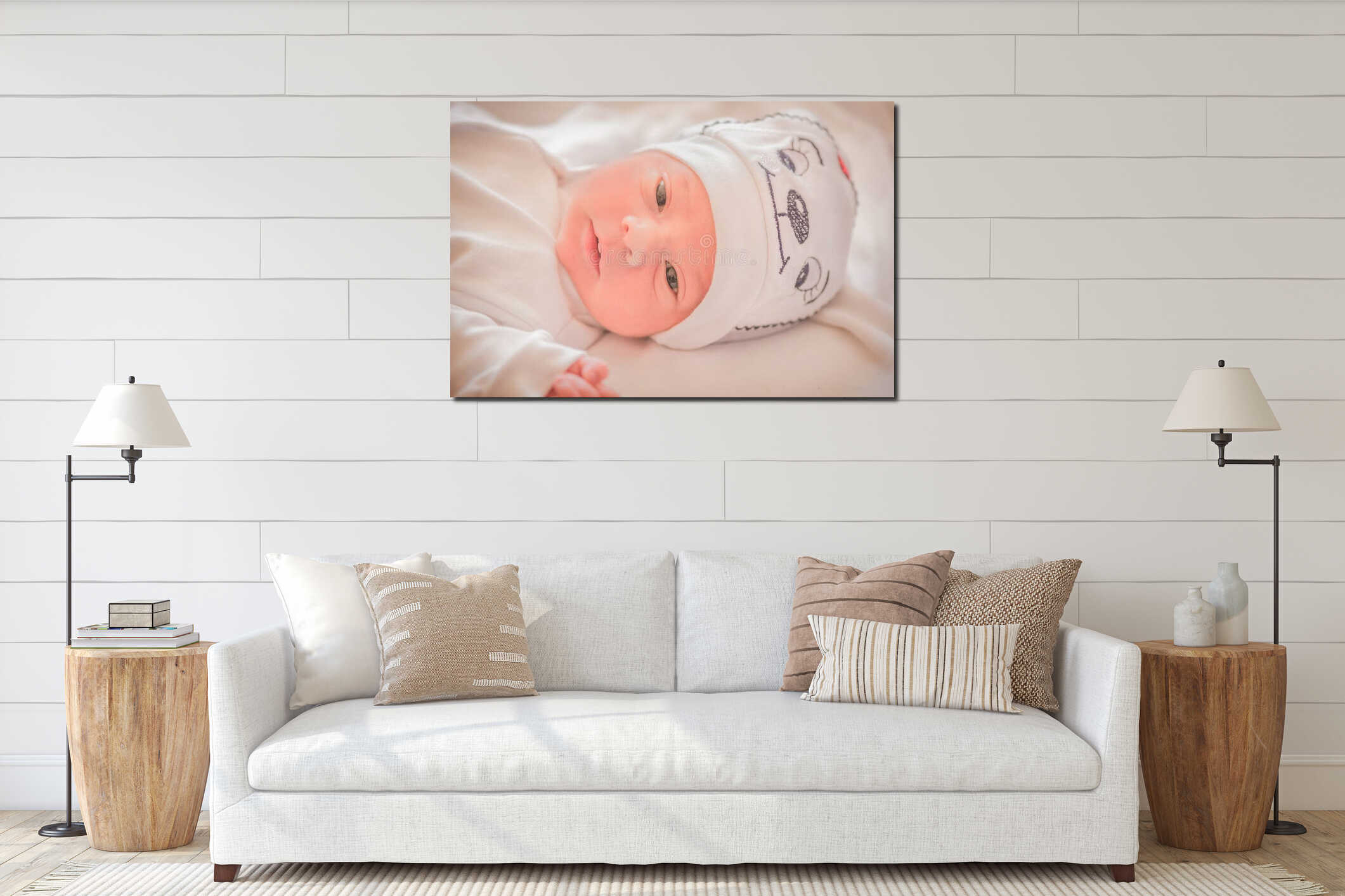 Close up of a newborn baby boy laying in the bed wearing a beautiful baby hat on interior mockup